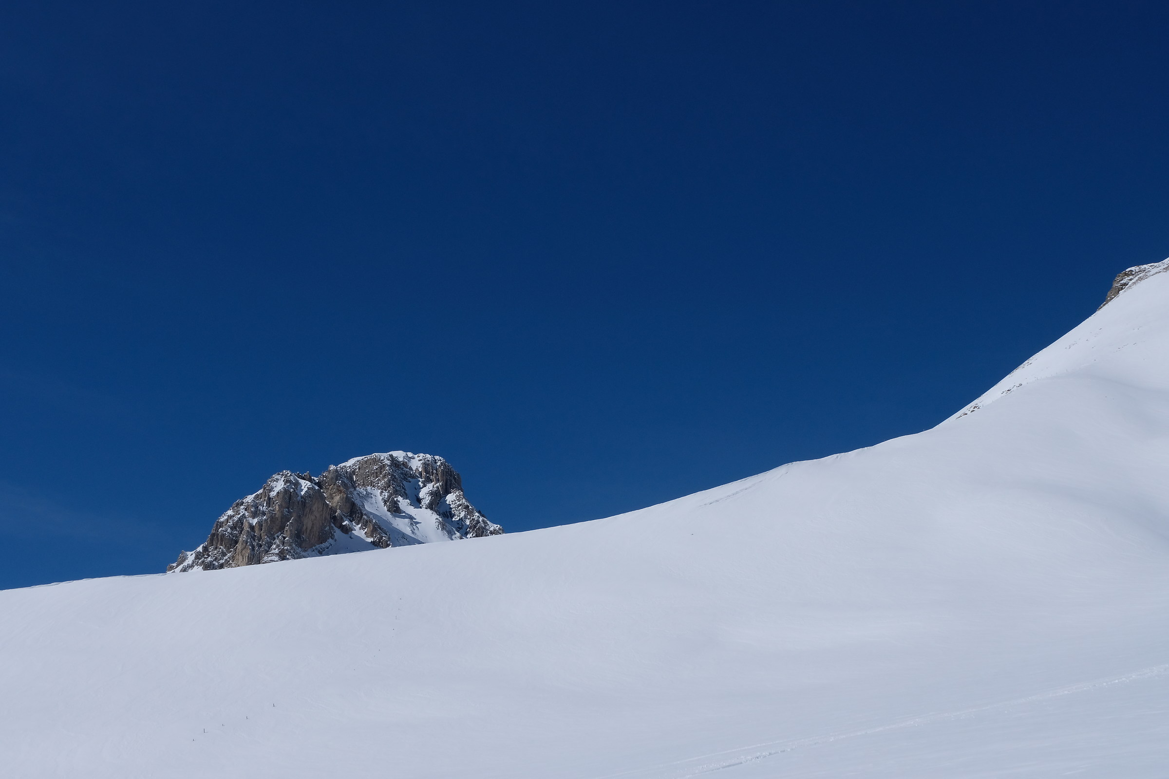 The blue sky stands out against the whiteness of the snow co...