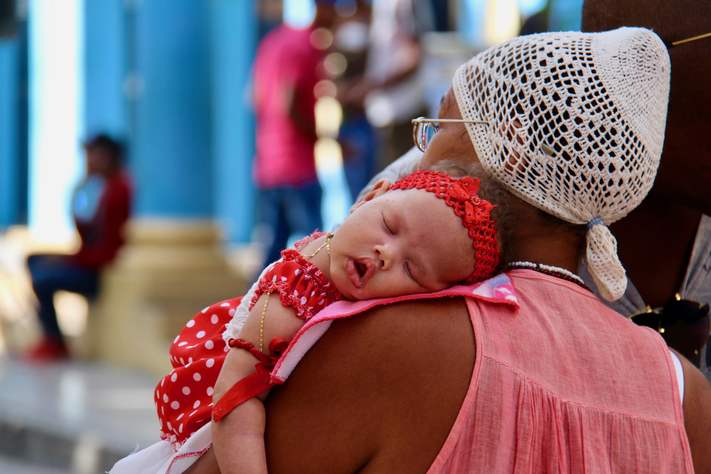 Little Guantanamo sleeps on his grandmother's shoulder