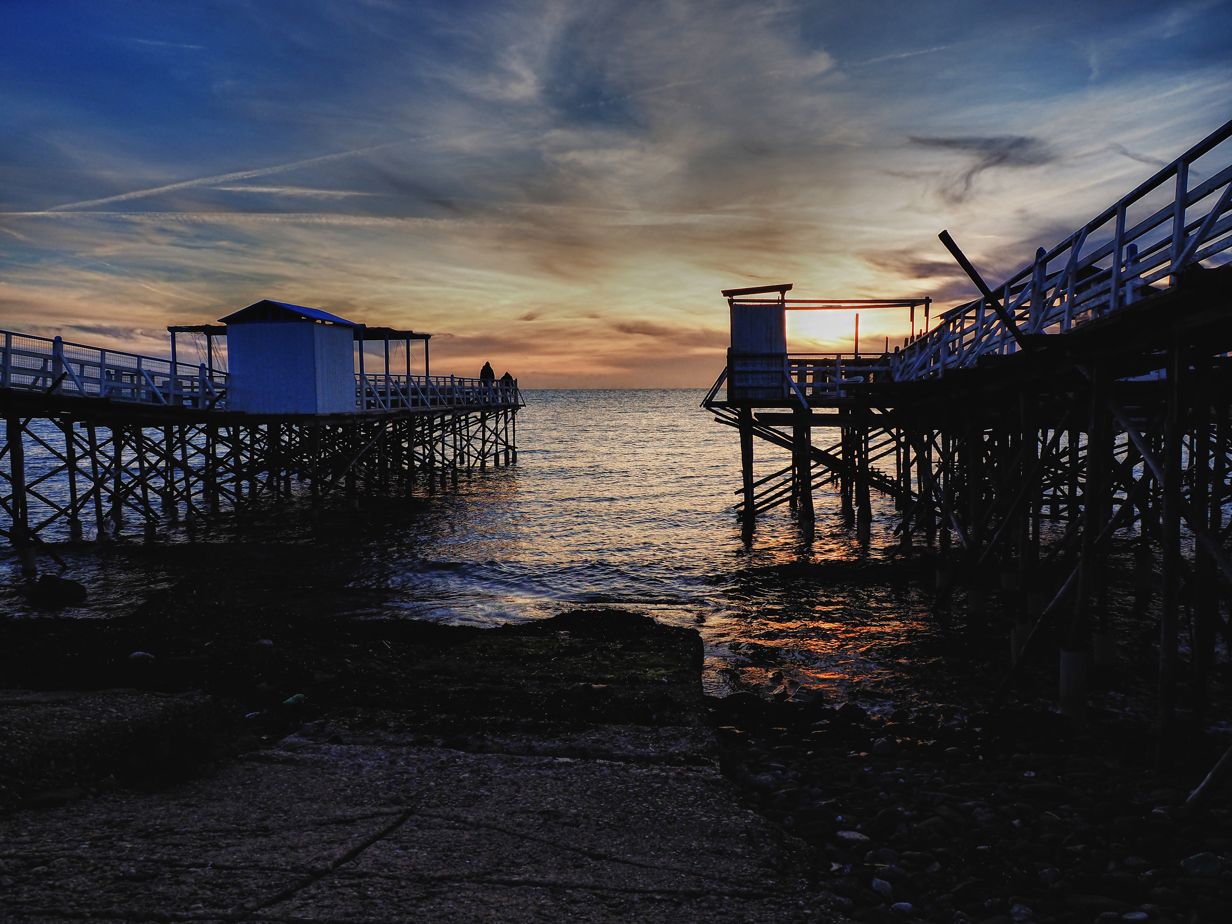 stilt houses at sunset