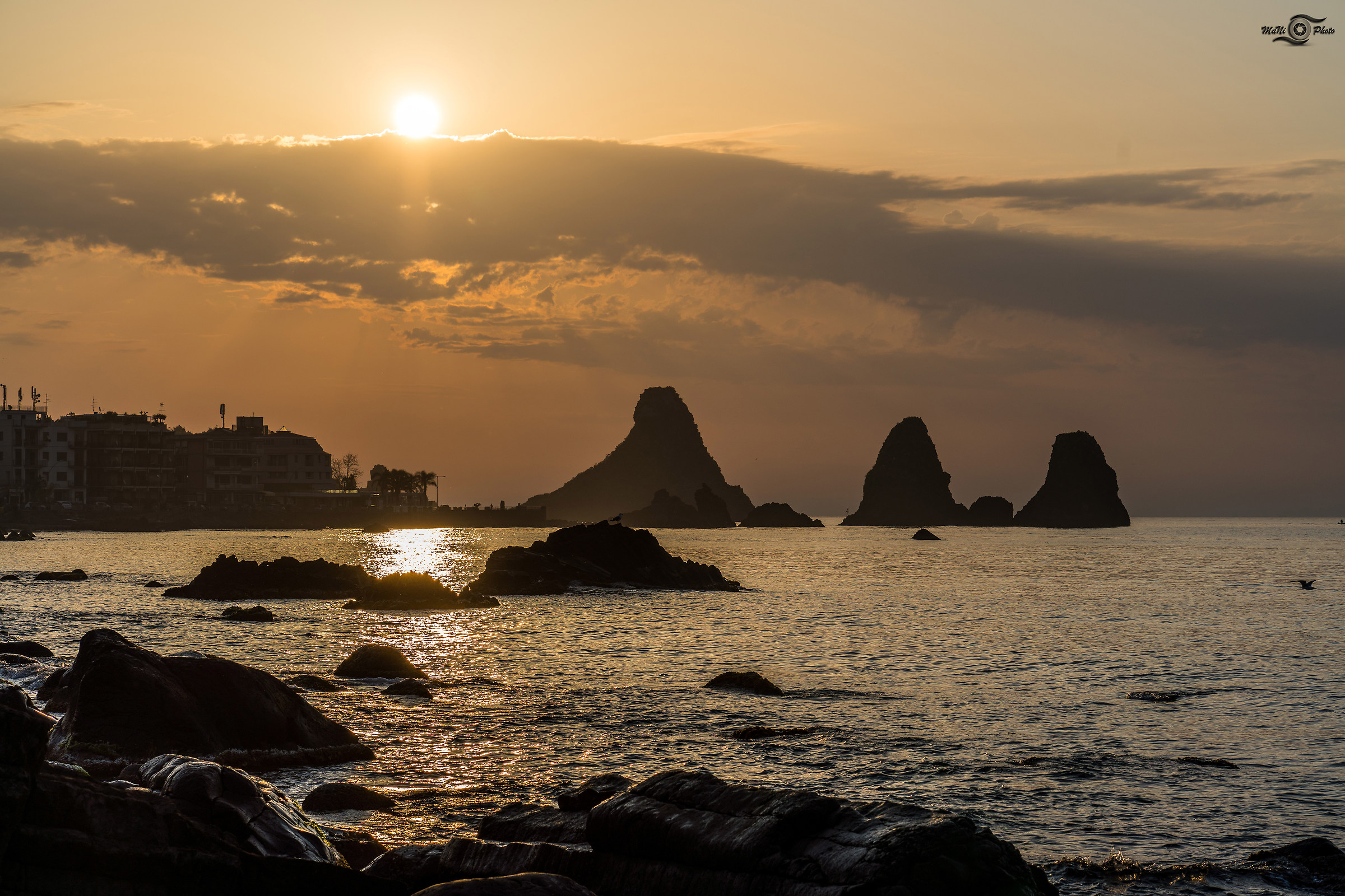 The sun peeps and lights Acitrezza