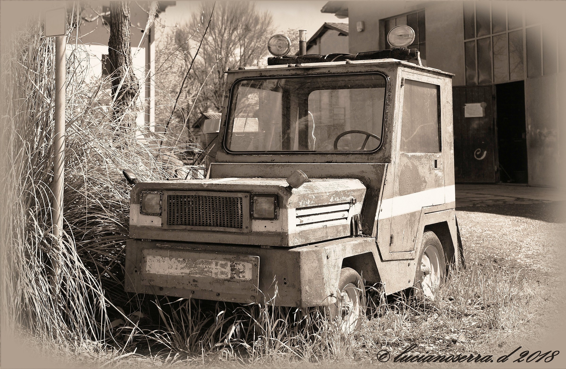 Old tractor trolling airport baggage