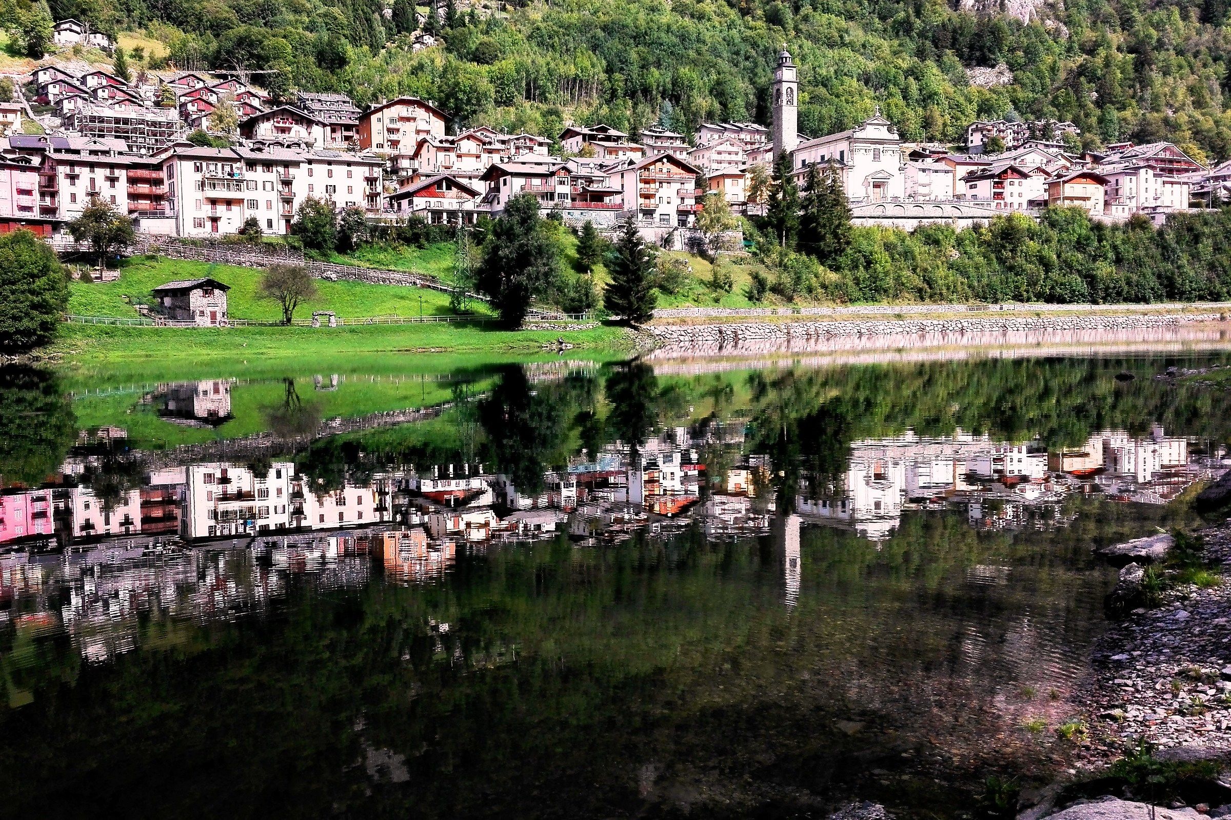 Carona (Alta Brembana Valley) is reflected in the lake