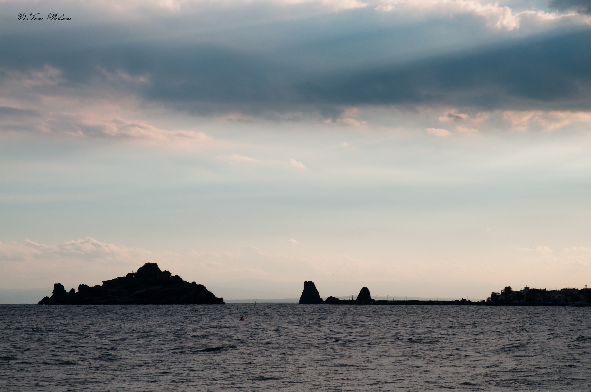Sunset on the stacks of Acitrezza
