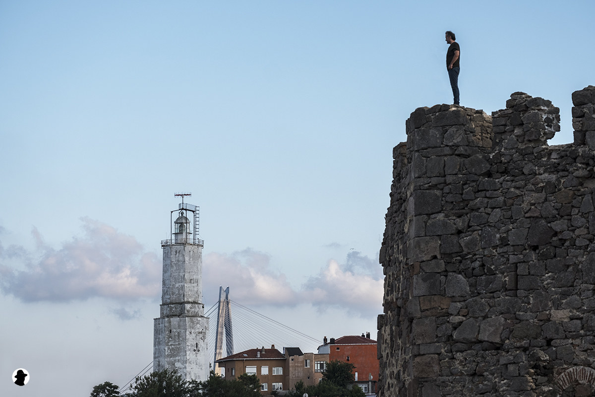 Man on Precipice with lighthouse