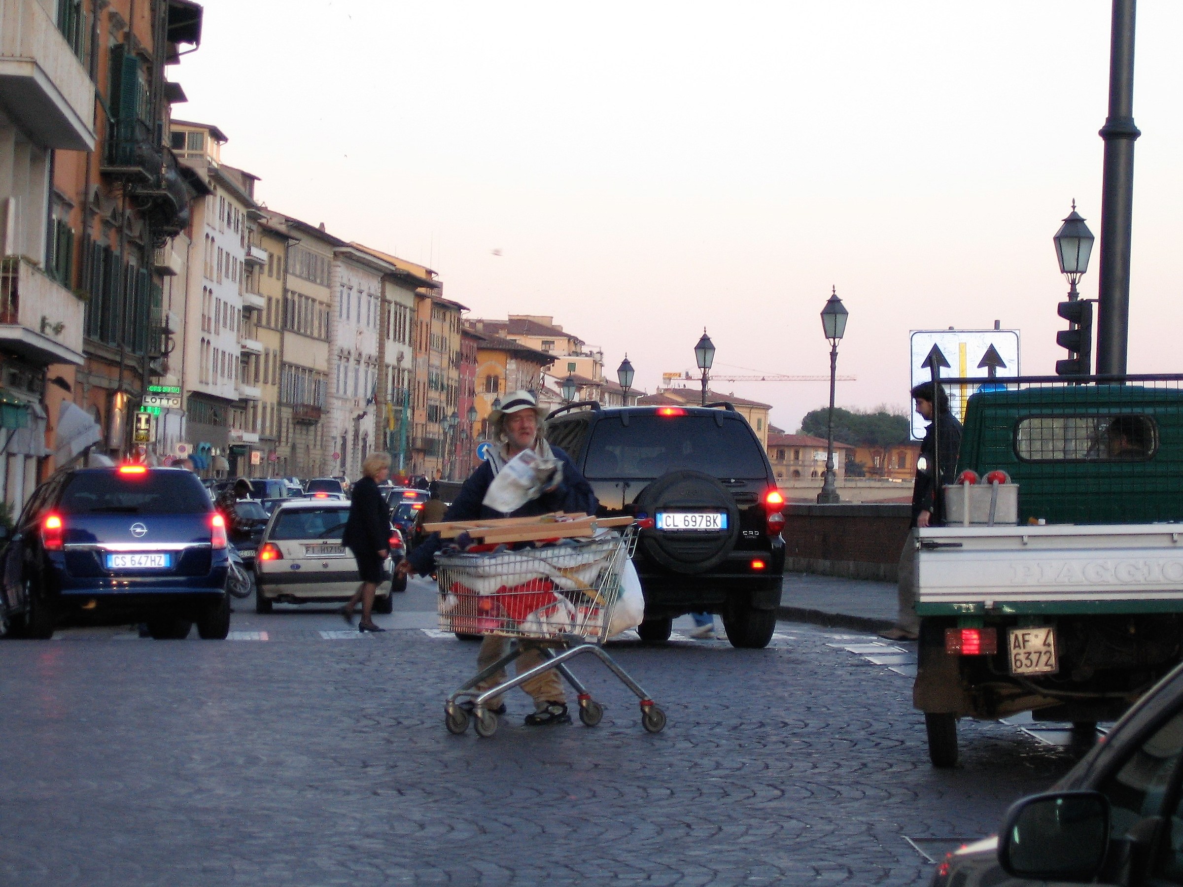 Beggar in the midst of traffic