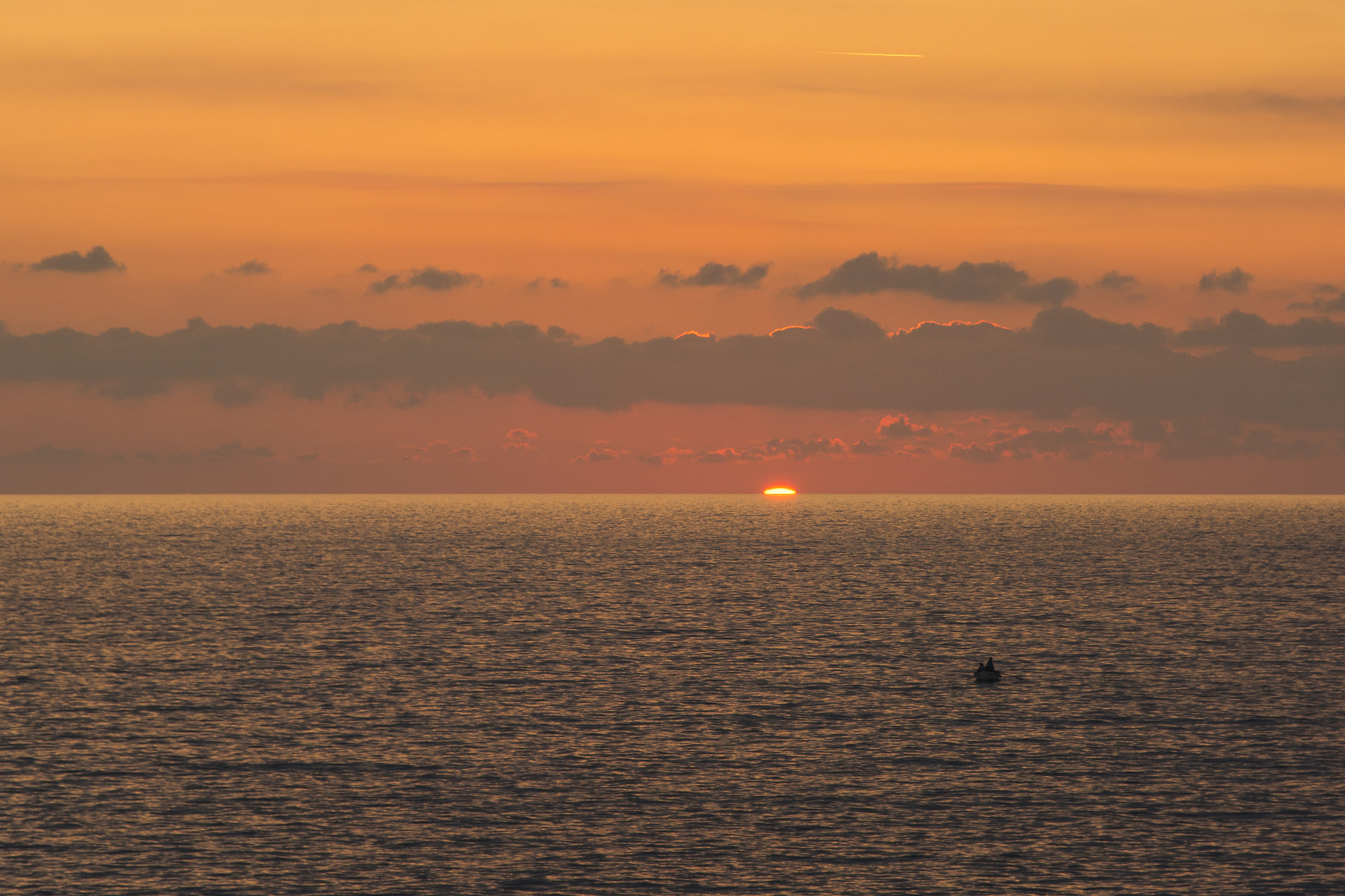 The last Sun.... and a fisherman