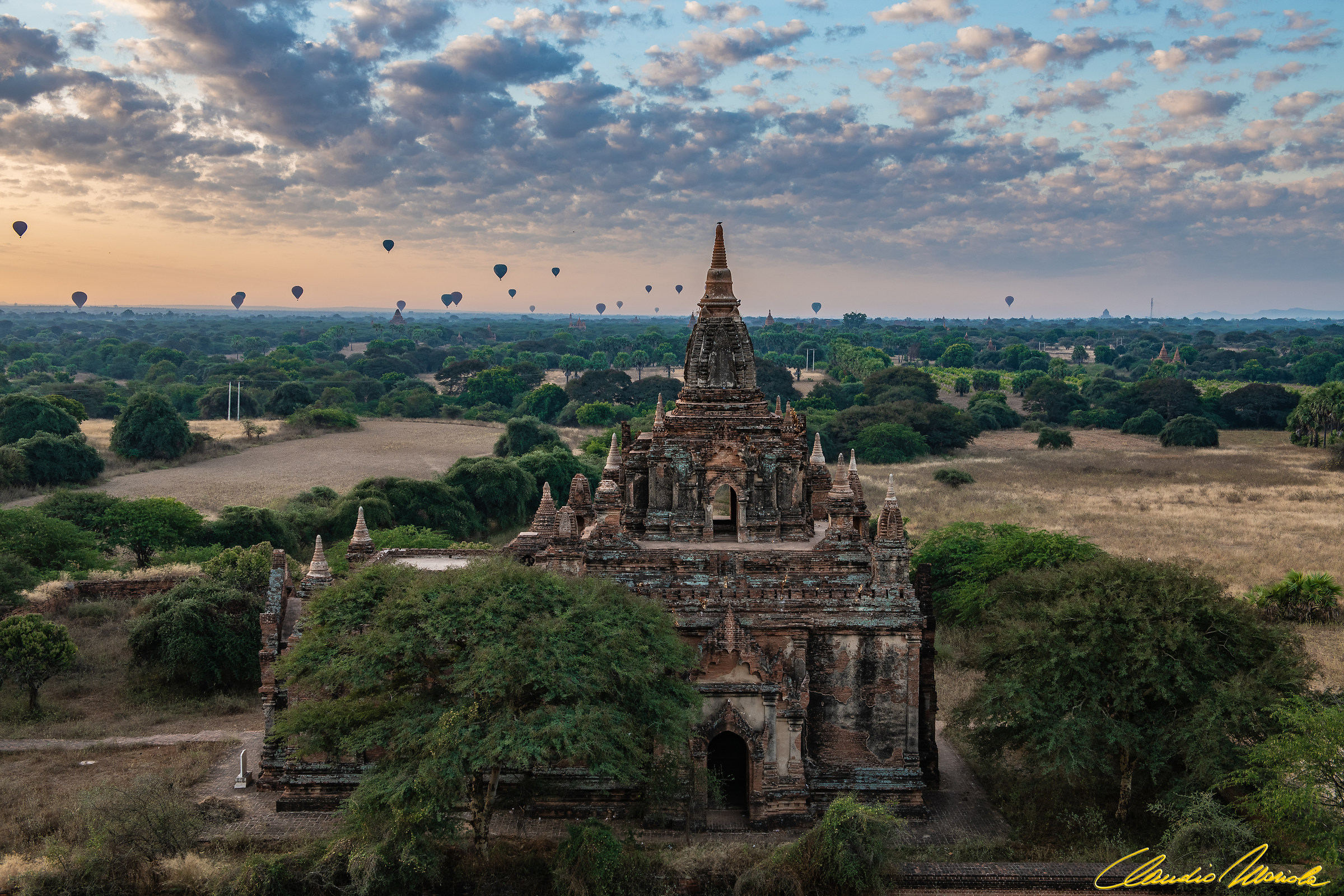 Balloons landing over temples in Bagan