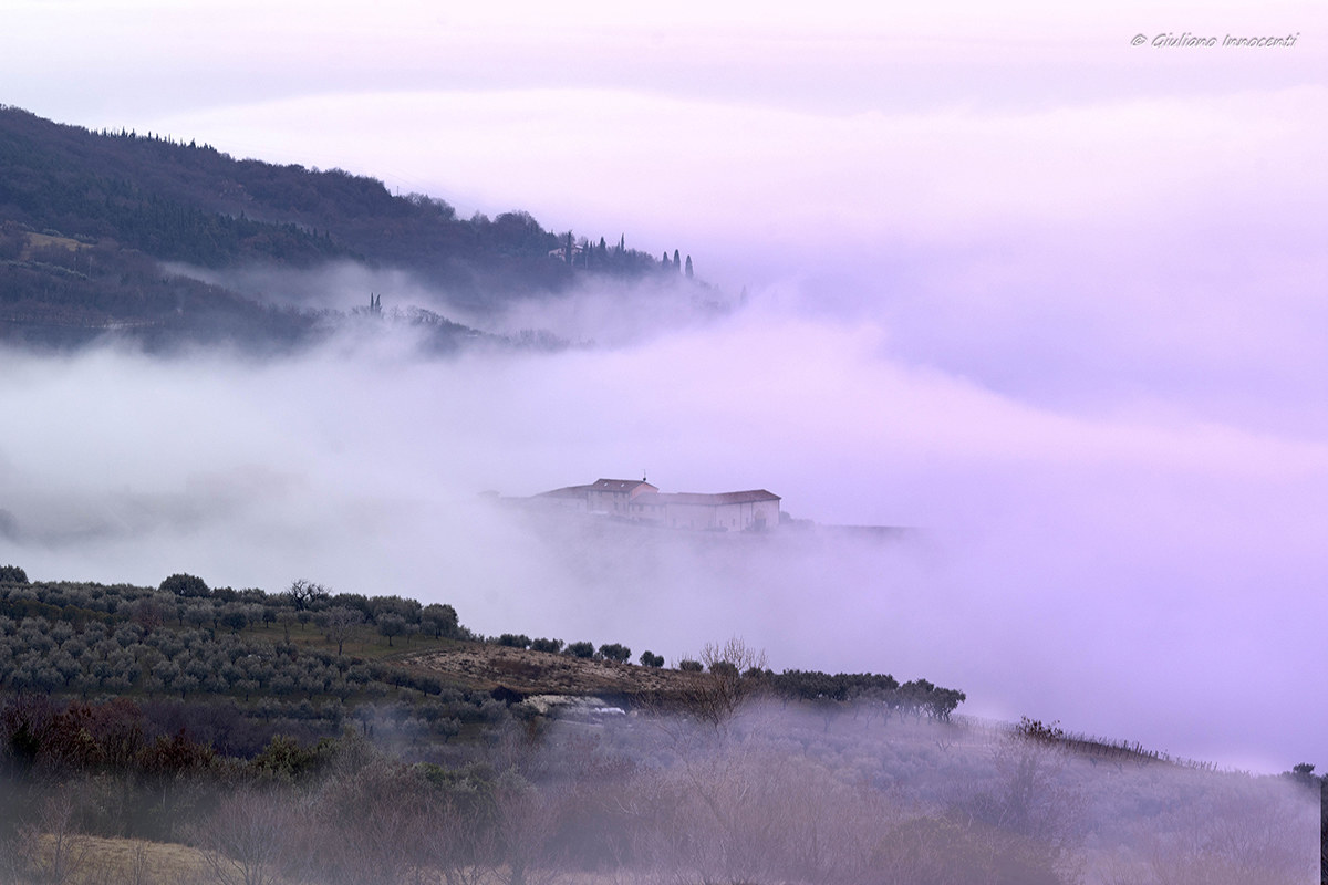 Sunset lights between sky, mountains and sea... fog