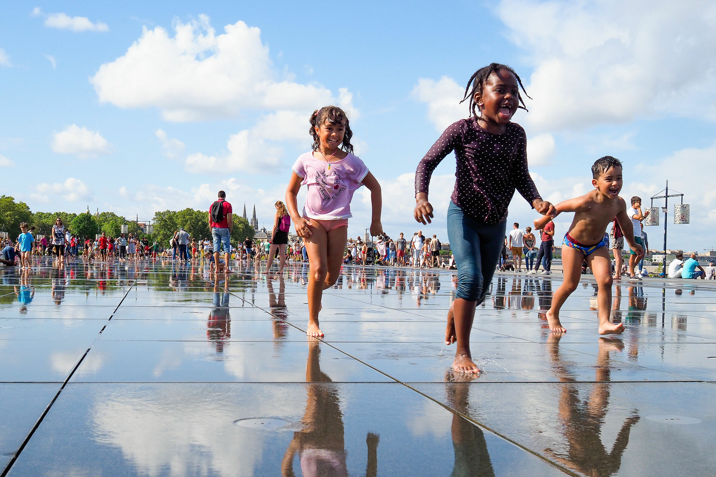 Happy kids at the water mirror of Bordeaux