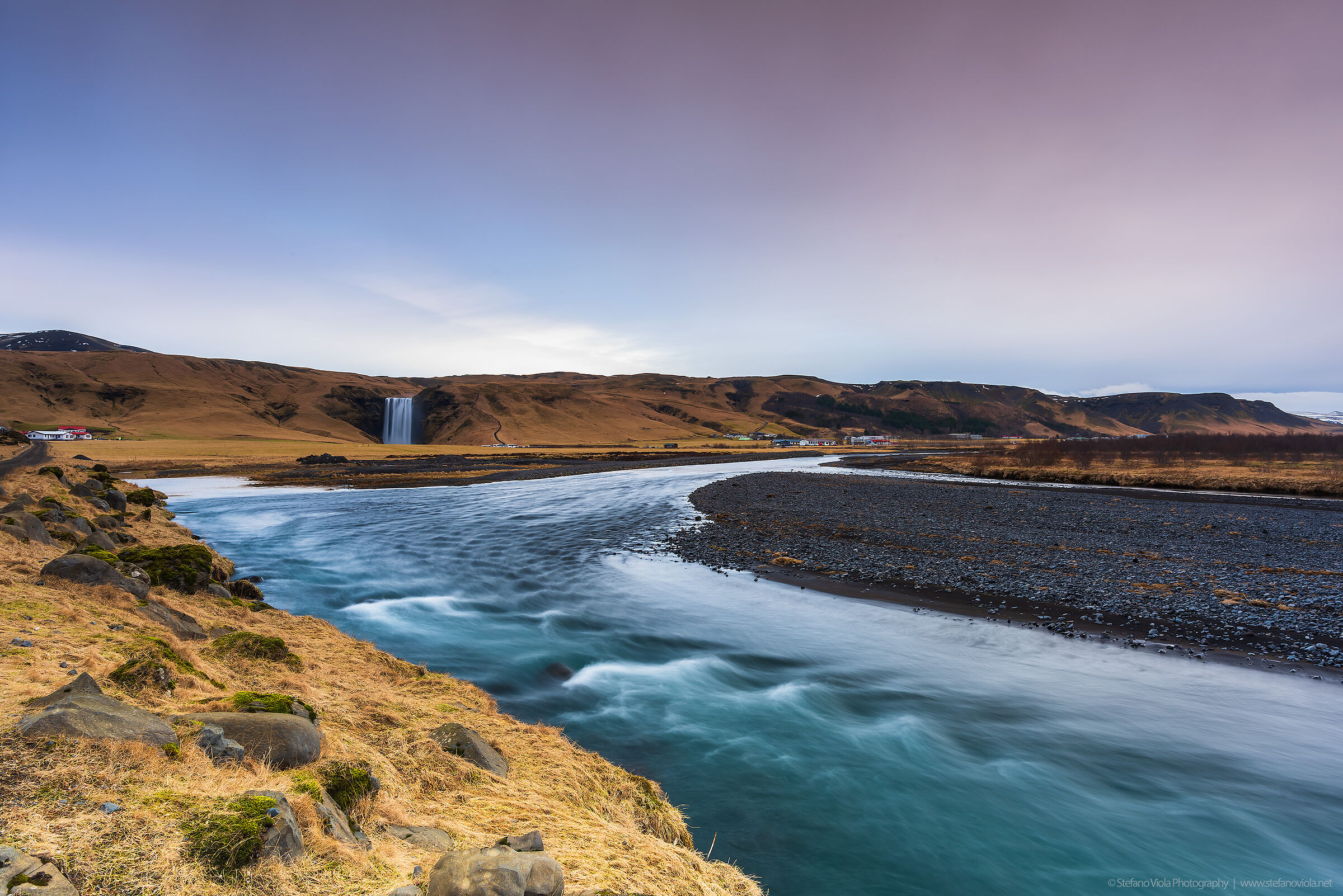 The first lights of the day illuminate Skógafoss