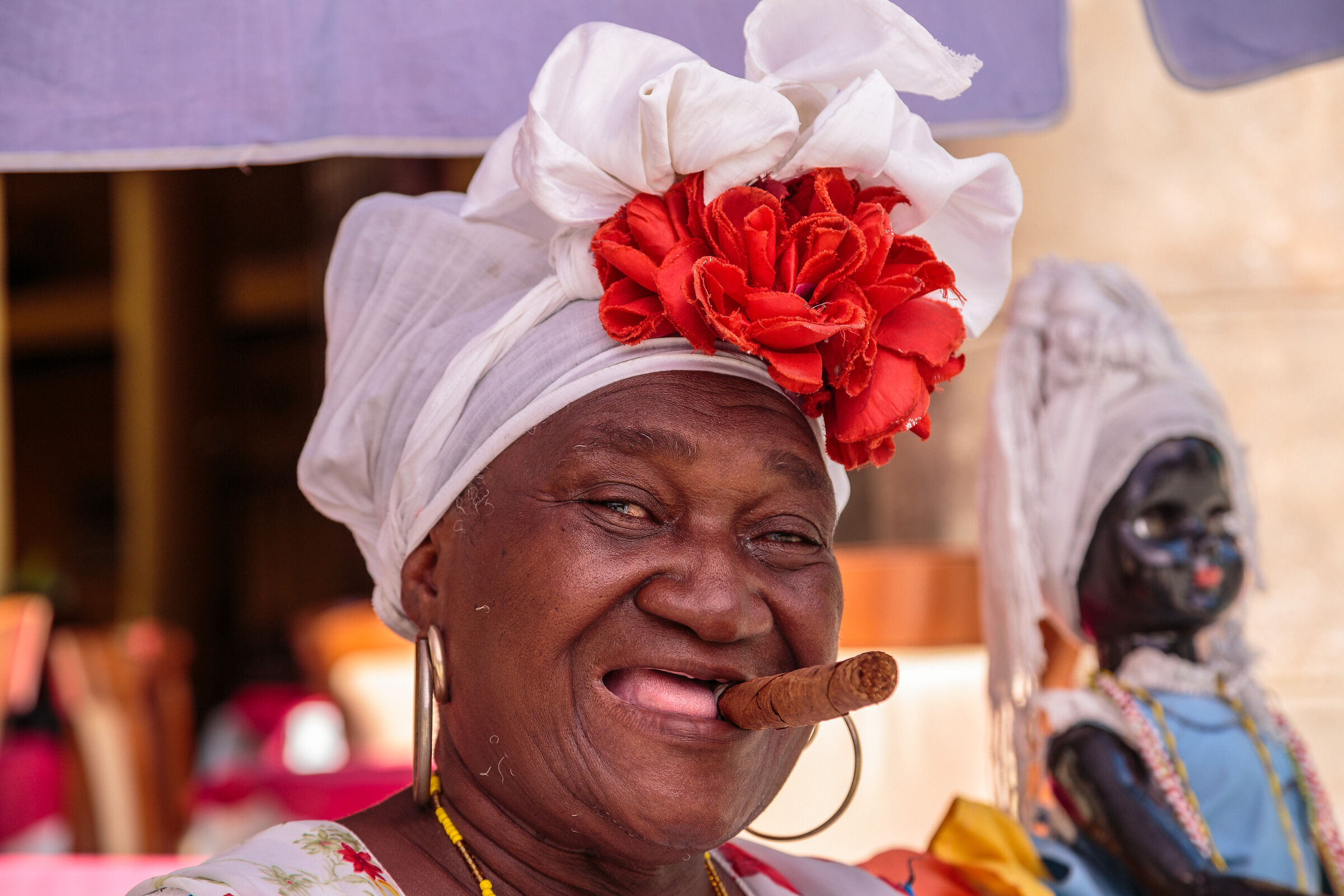 Old lady in colorful dress with Cuban Cigar