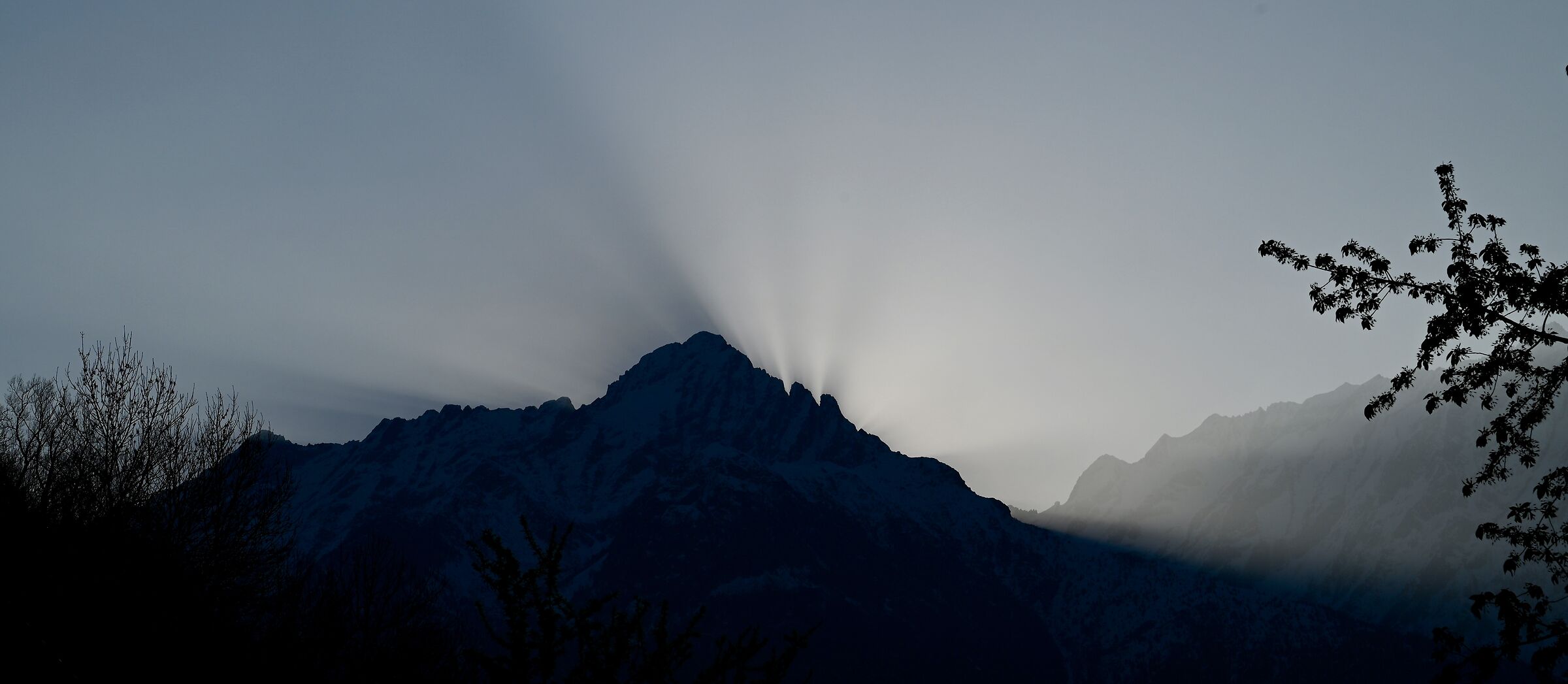 The sun rises behind Mount Aviolo (Valle Camonica)