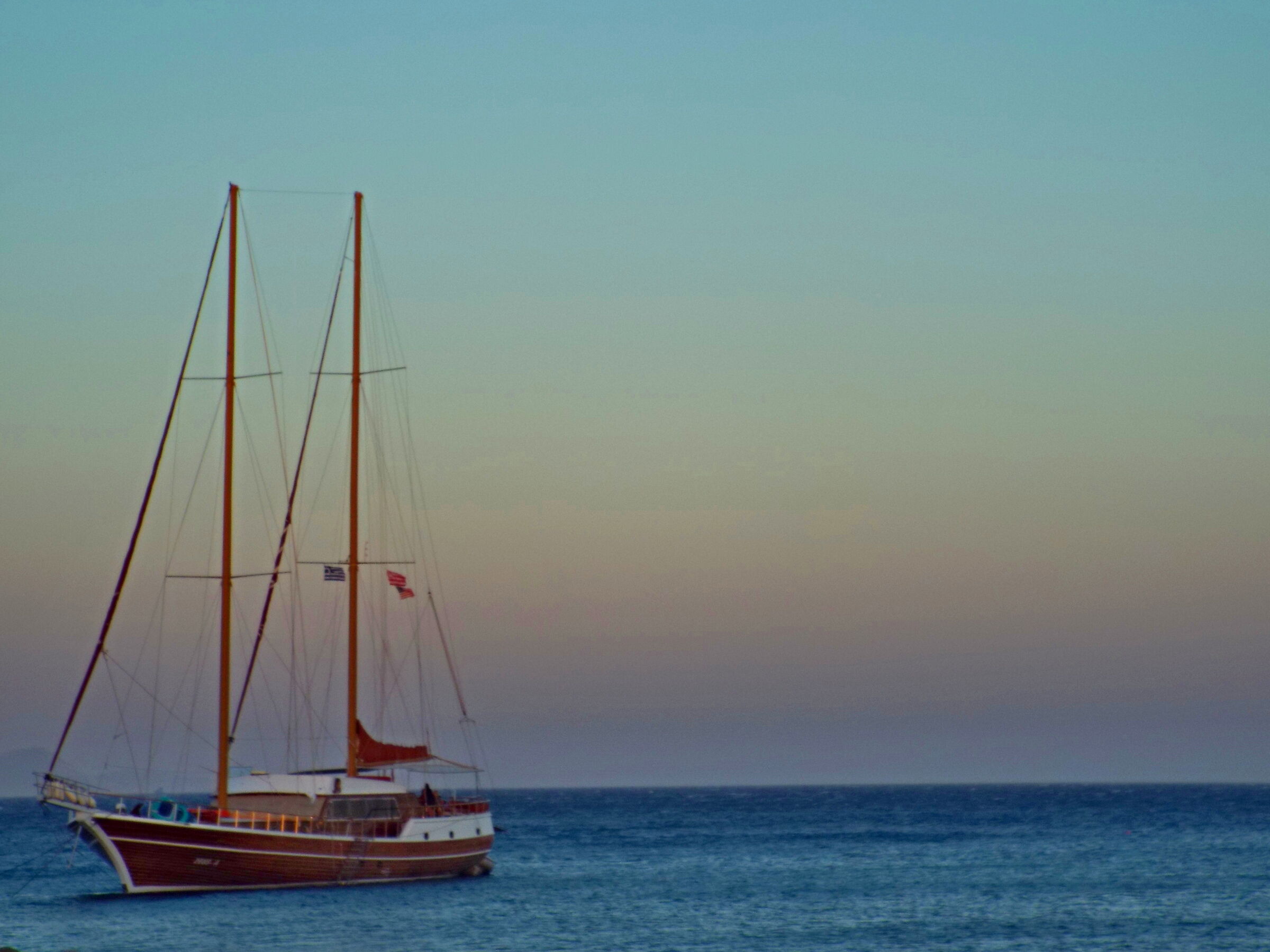 the sailing ship stops to observe sunset