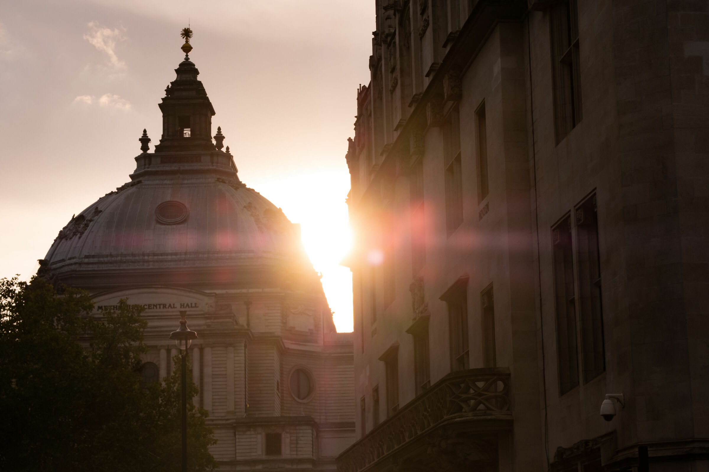 The sun between the rooftops of Victoria Street - London