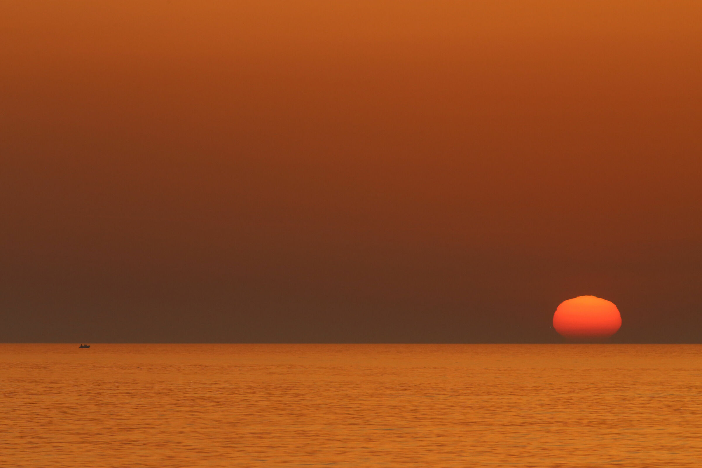 A boat towards sunset
