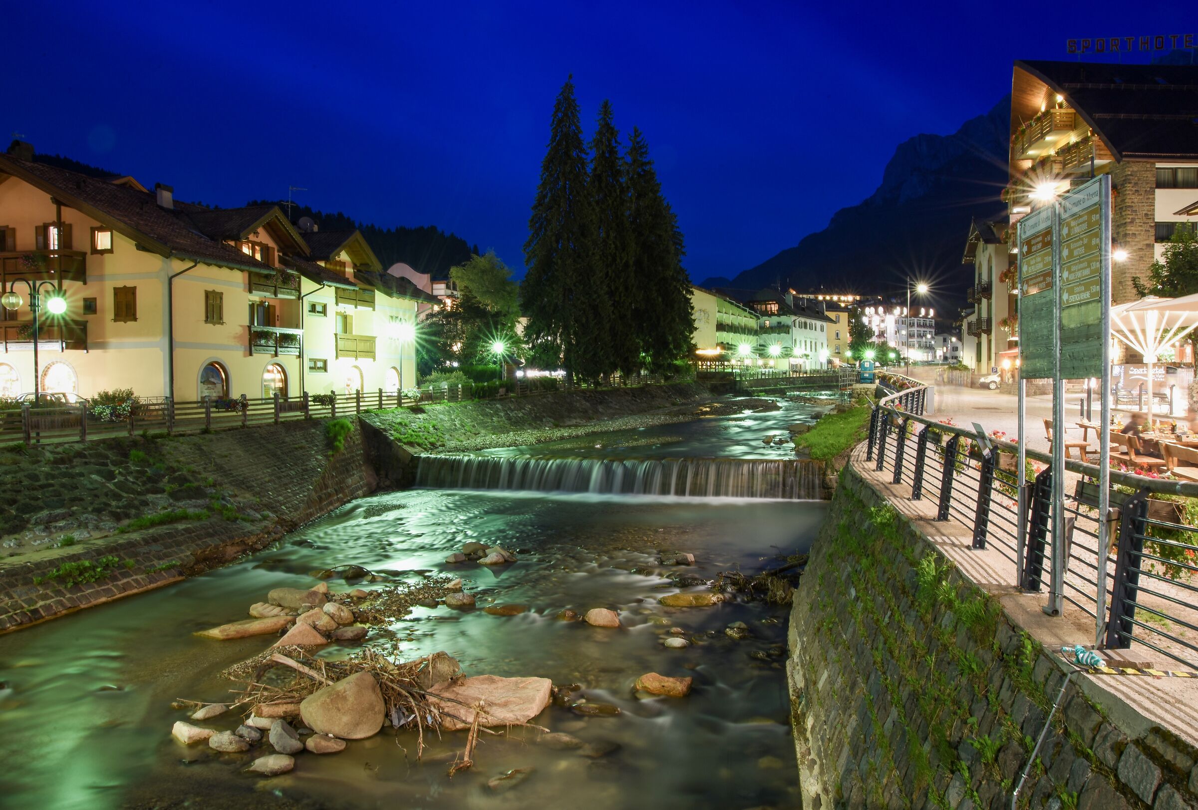Moena by Night and the Avisio River that crosses it
