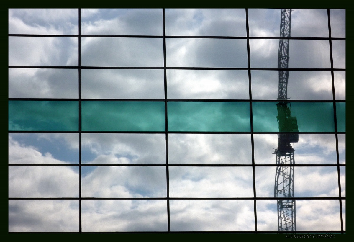 Reflections of clouds and cranes