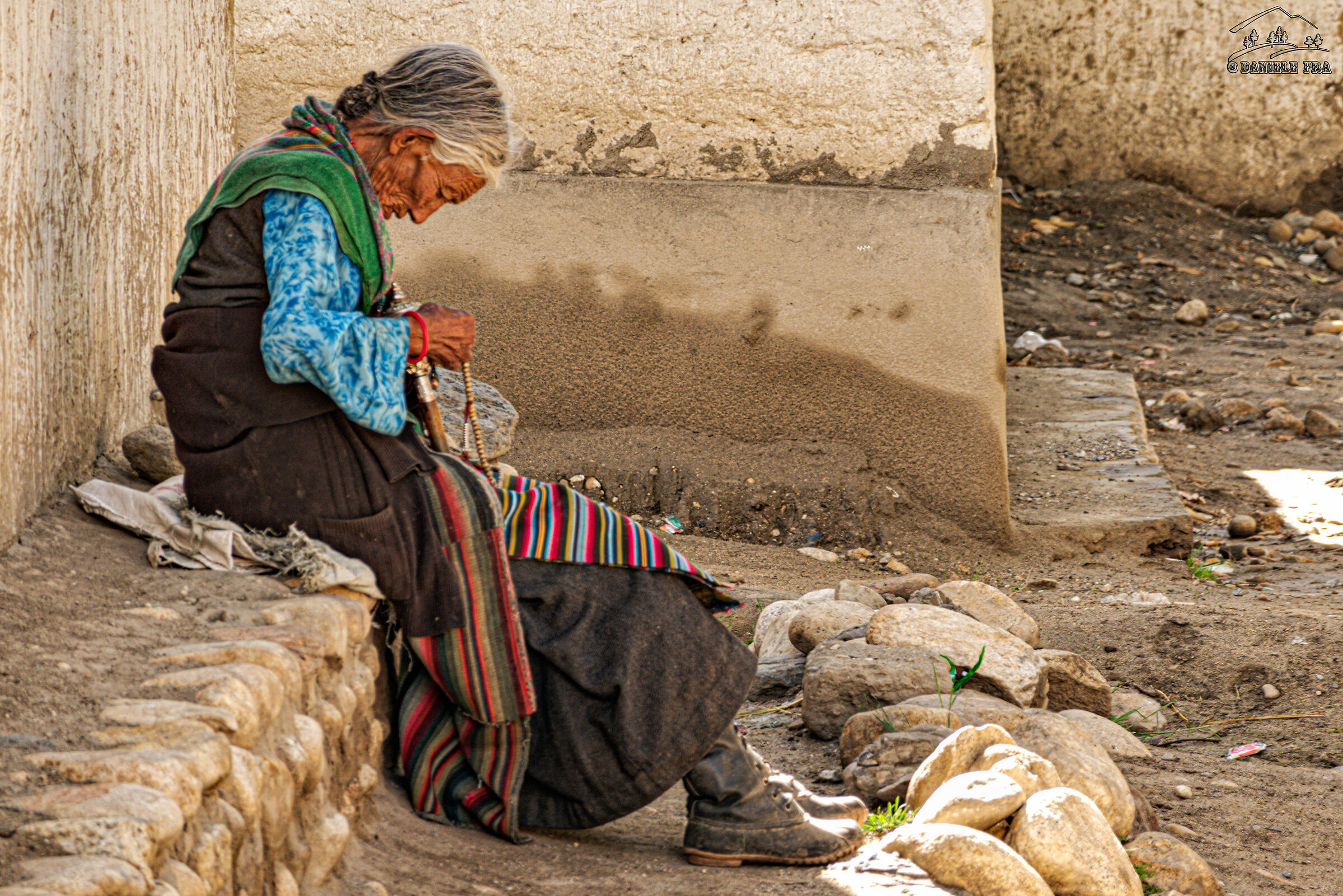 Elderly woman praying in Lo Manthang
