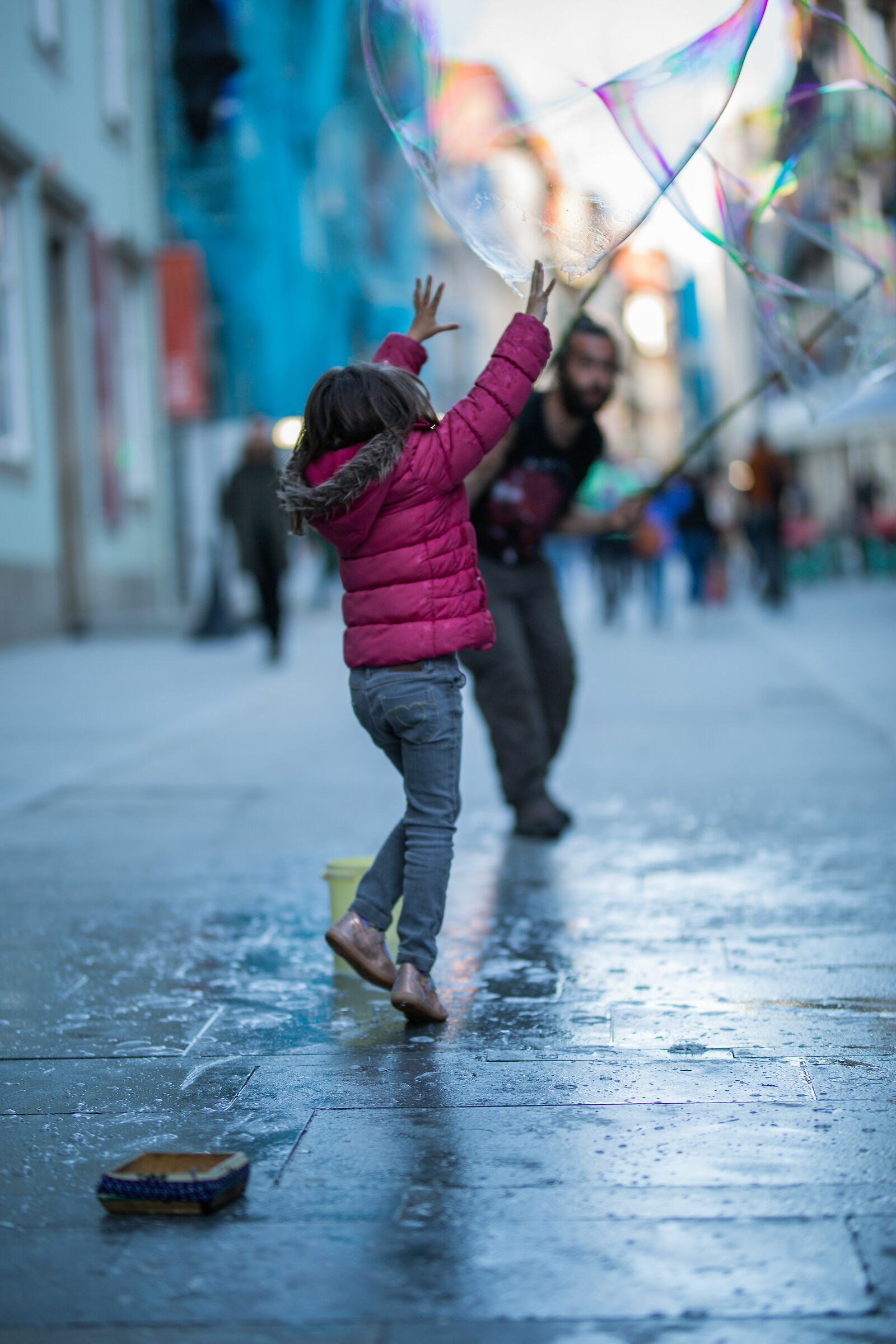 Little girl playing with water bubbles