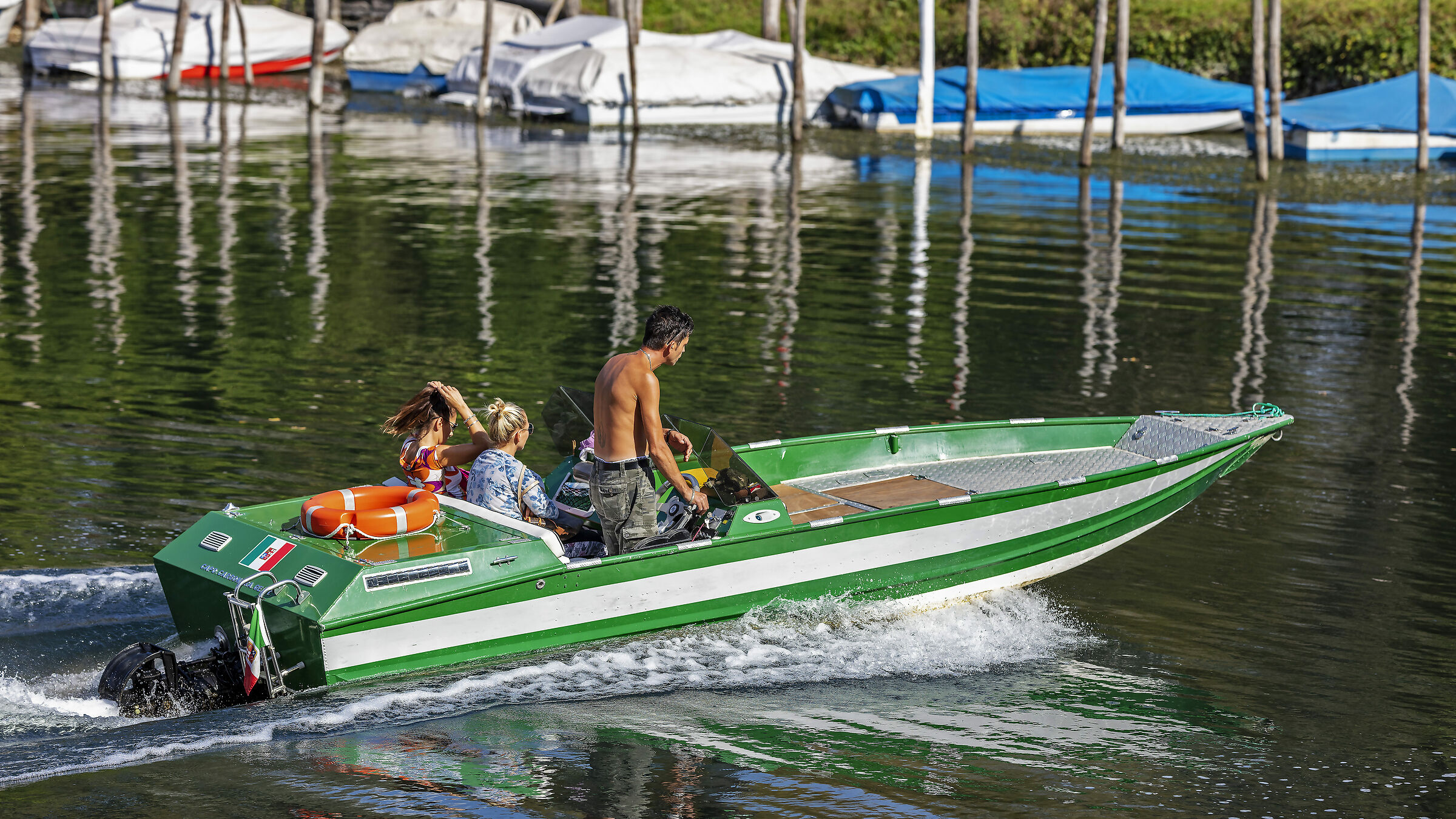 A sailor with two ladies makes the figure of salami