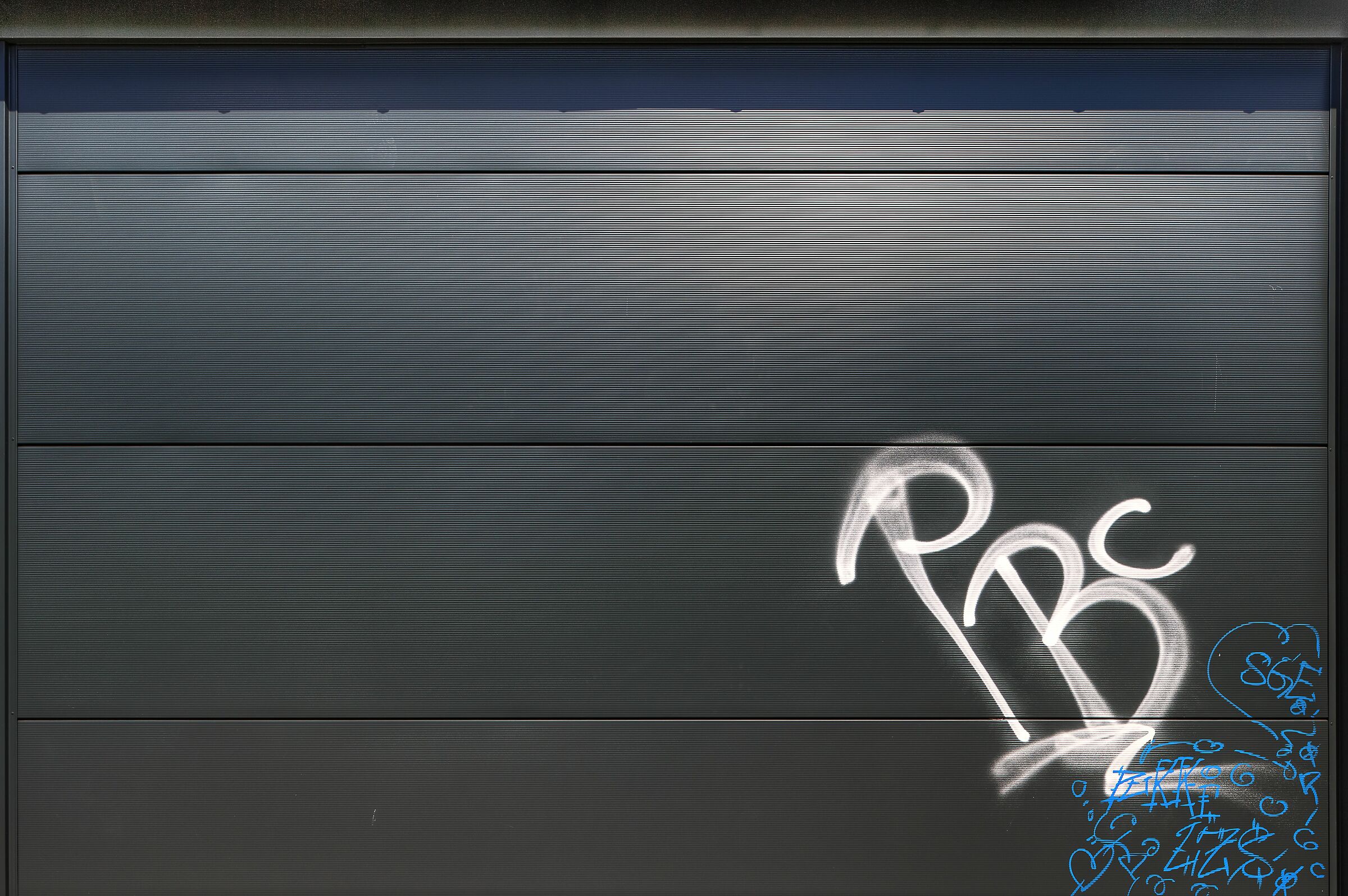 Black Metal Cladding with Graffito, Wiesbaden, Germany