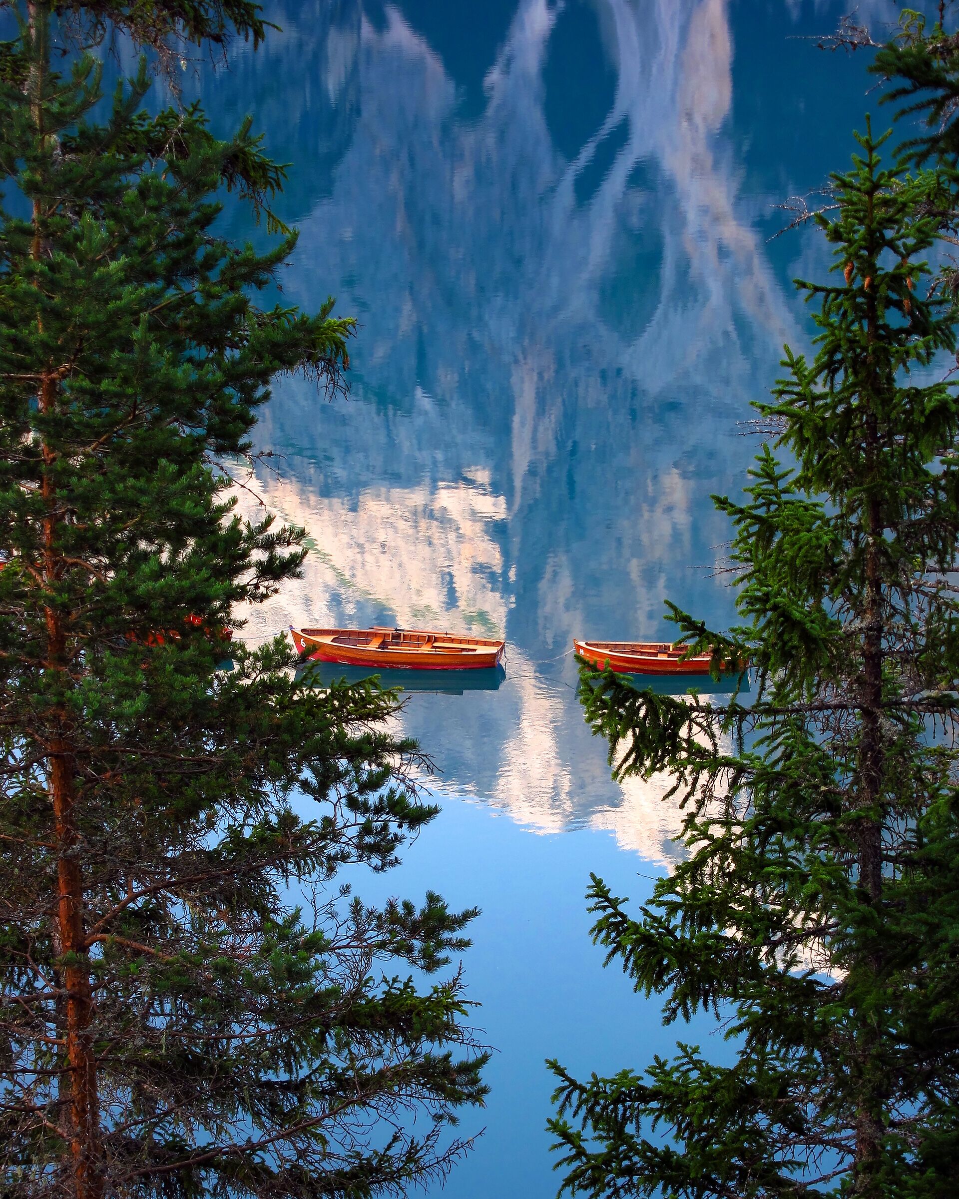 Boats floating on reflection