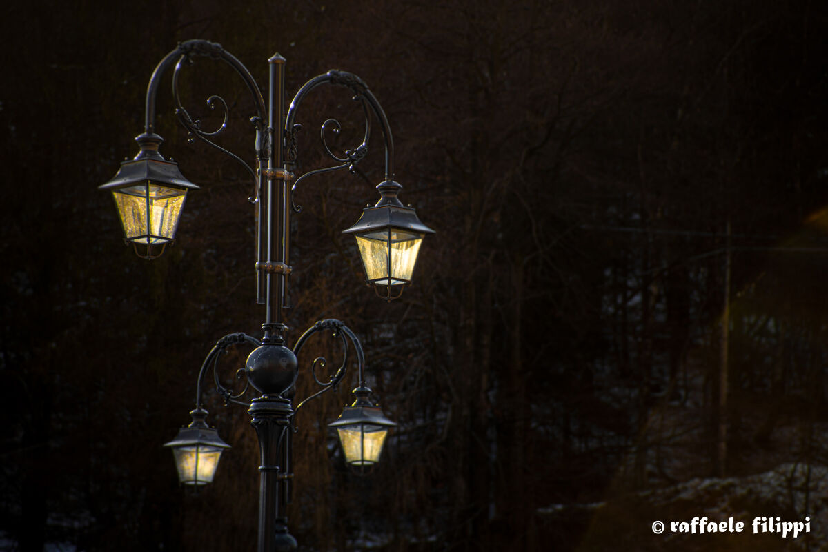 Last rays of light on the lampposts of Oropa - Biellese