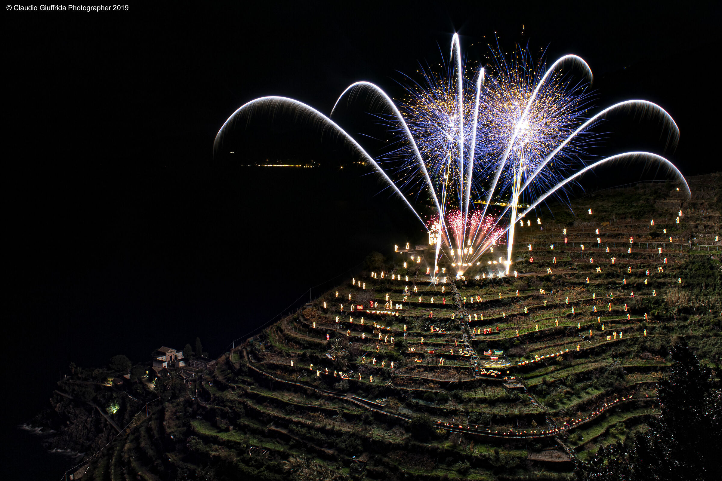 Lighting the Nativity scene of Manarola