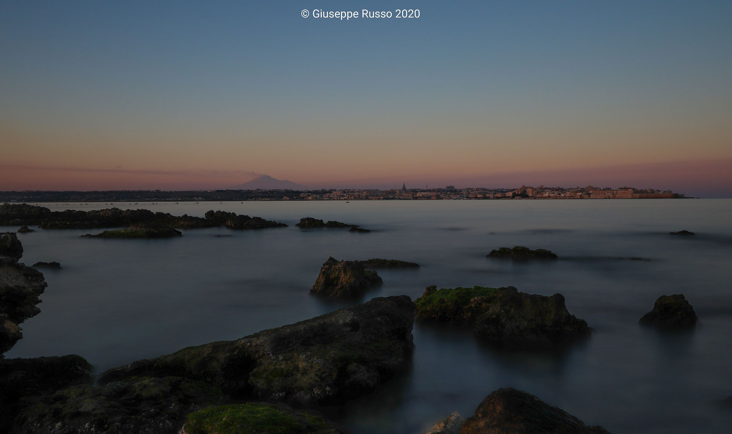 View of Mount Etna between sea and Syracuse
