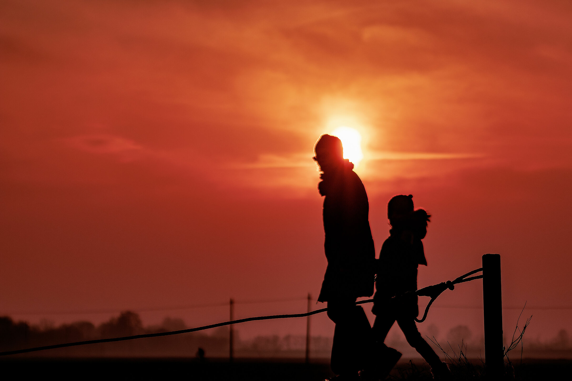 An old man and a child take hold of the hand