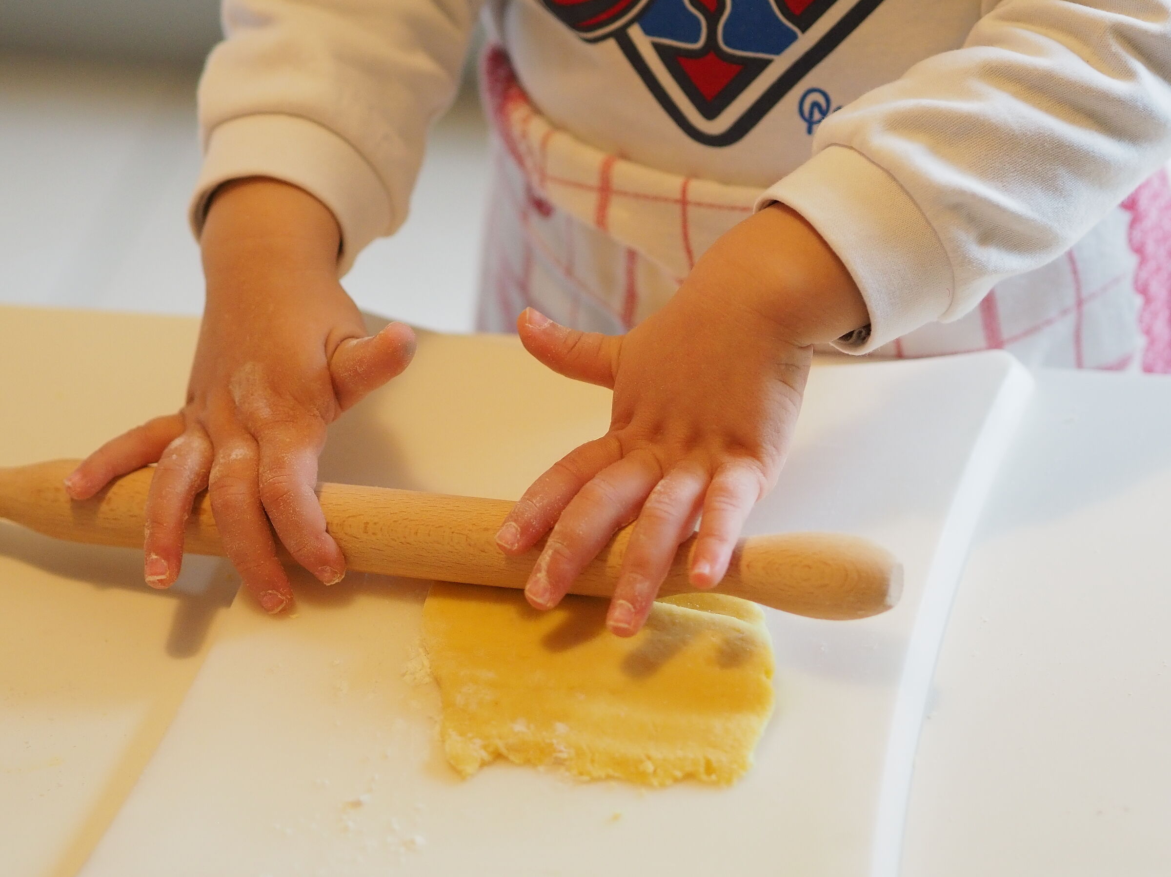 18 months old little hands preparing pasta