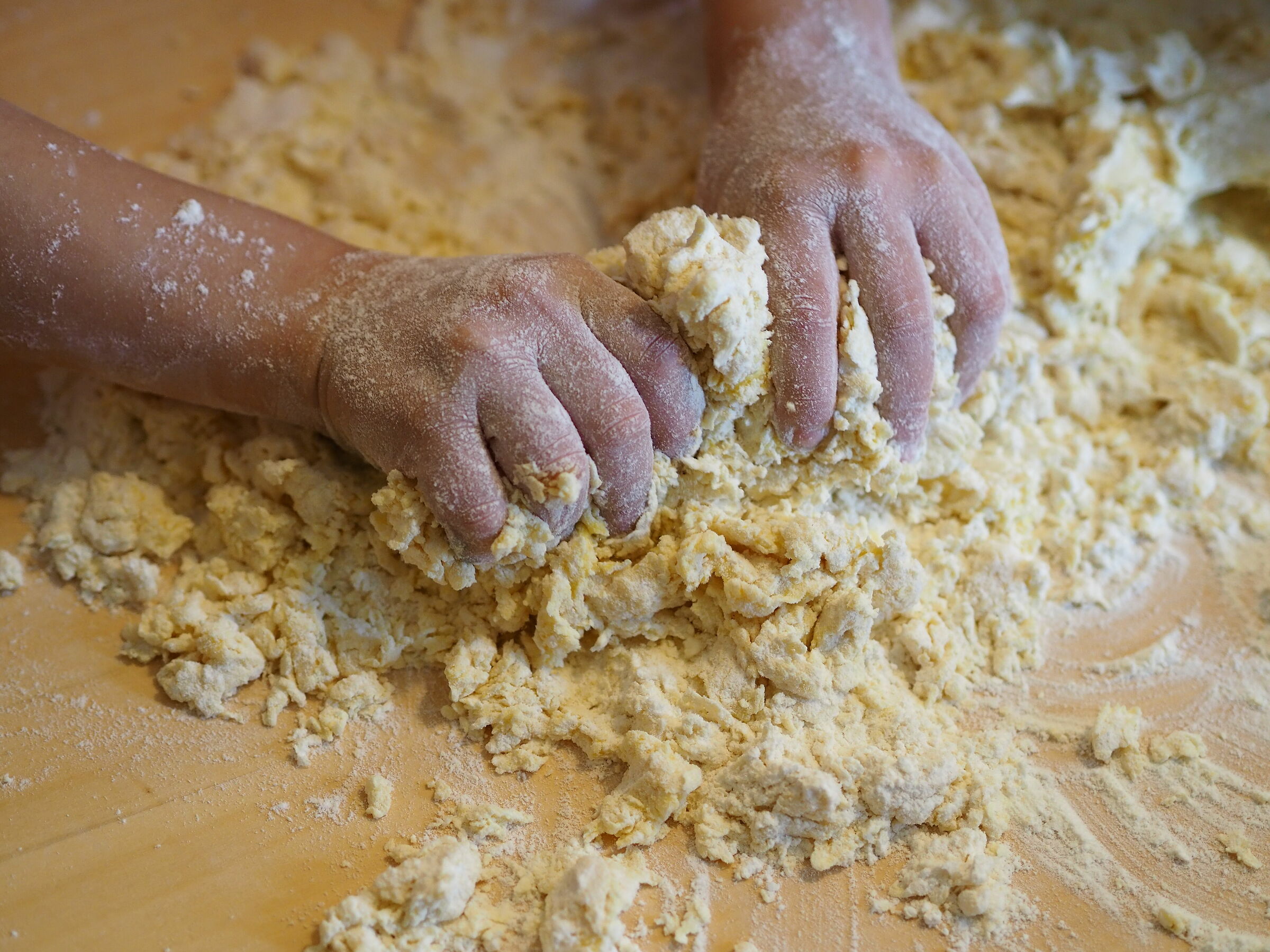 4 years old little hands preparing pasta