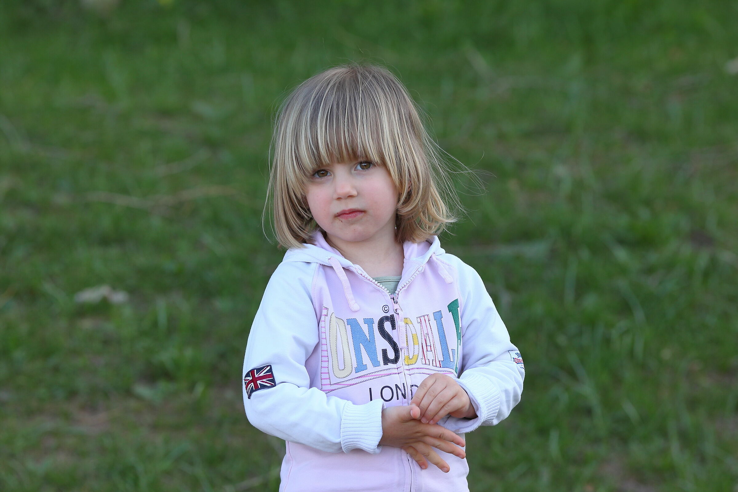 A little girl with a little hair a little too long