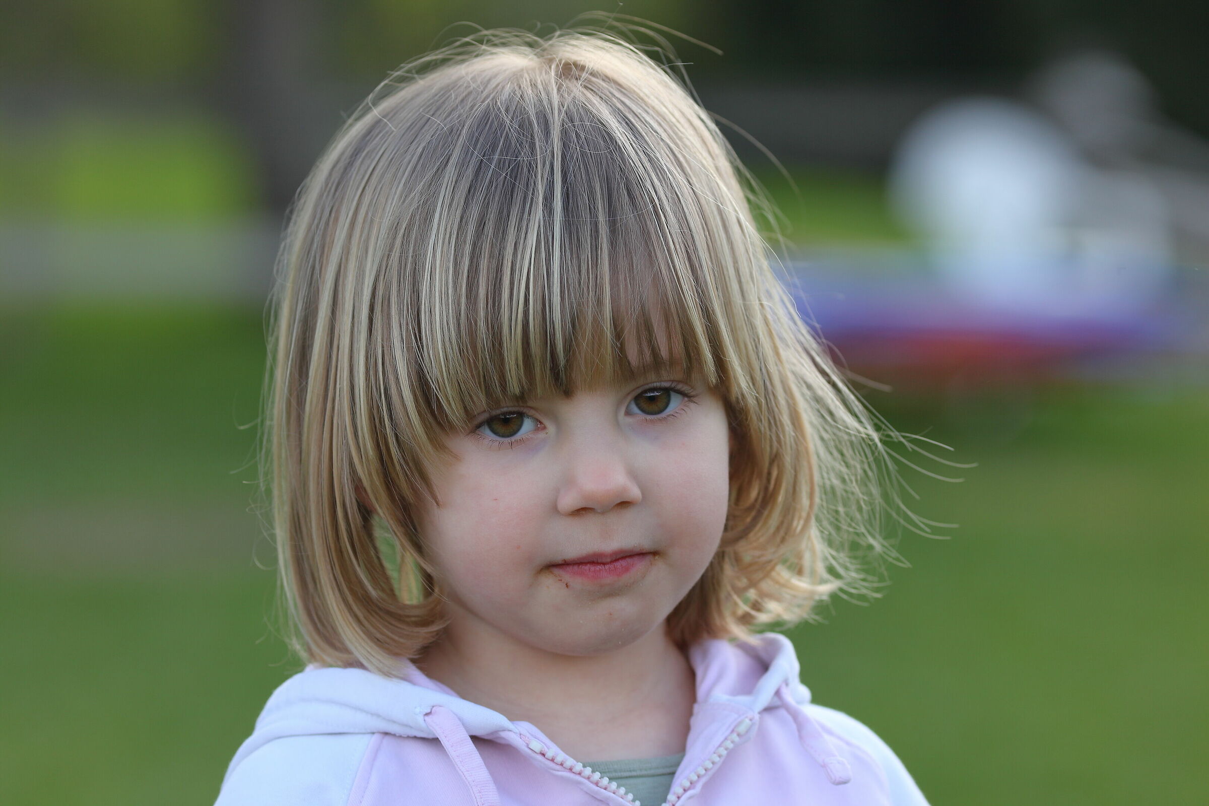 A little girl with a little hair a little too long