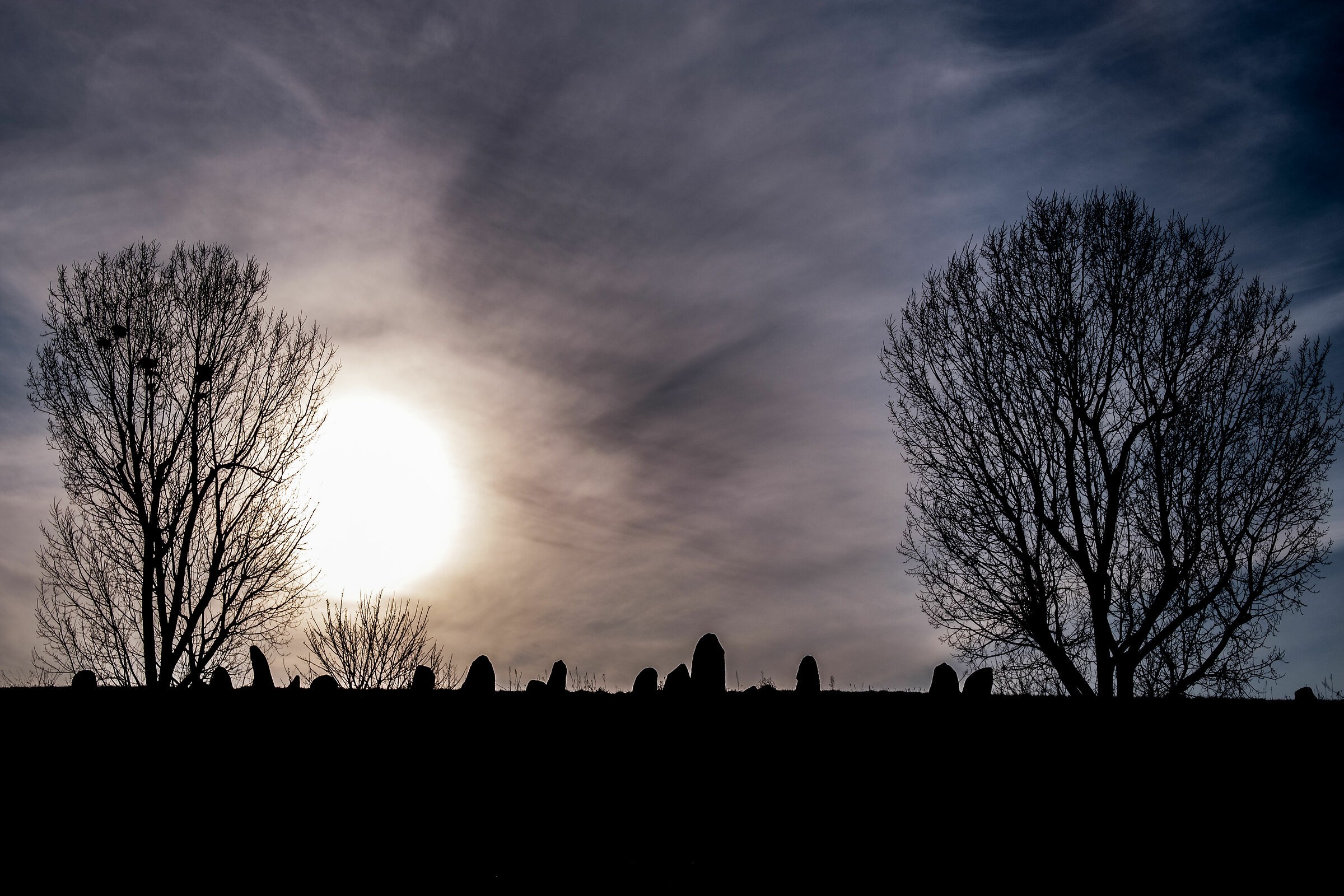 Sun over old jewish cemetery in &Lstrok;omza, Poland