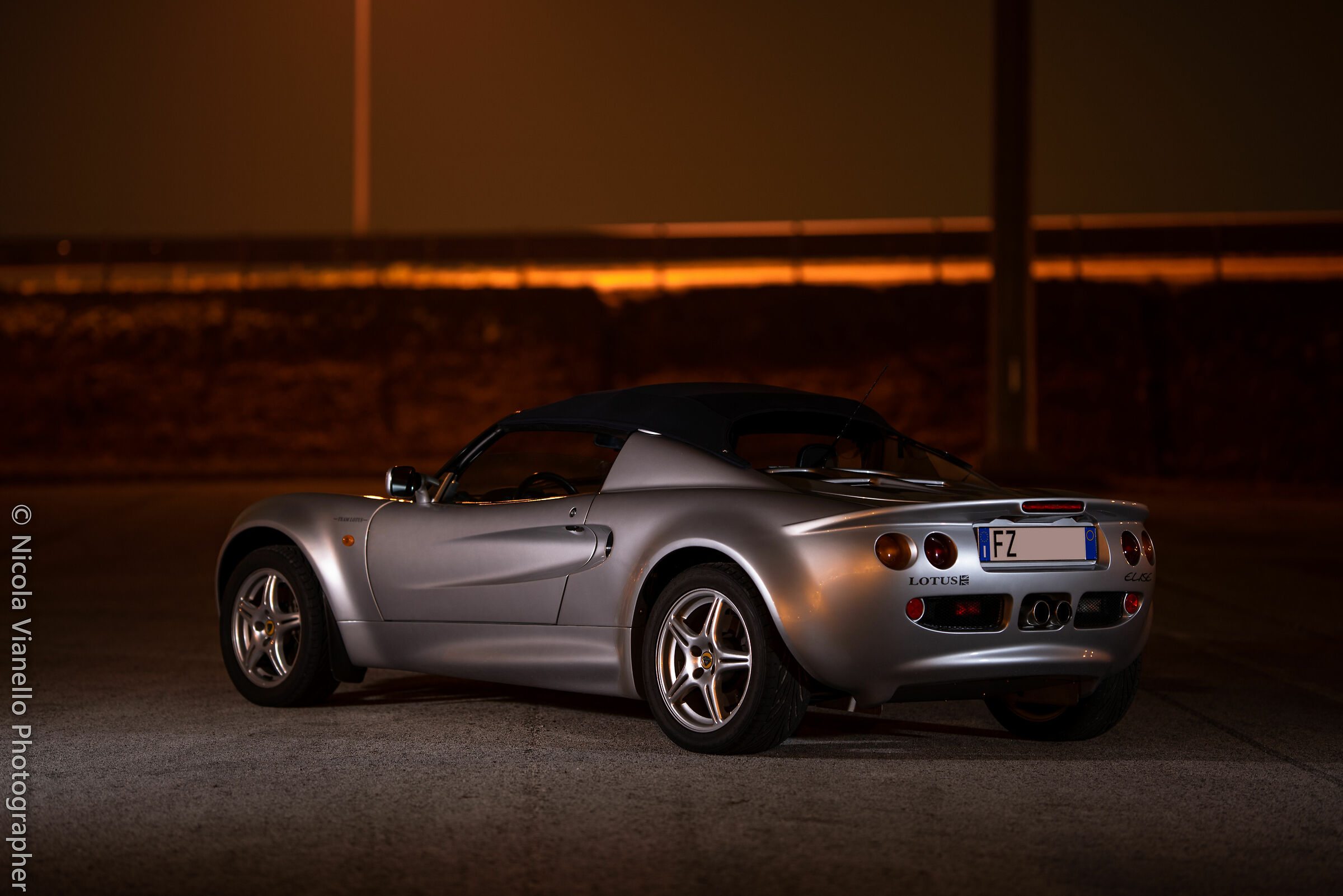 A Lotus Elise in a park by night