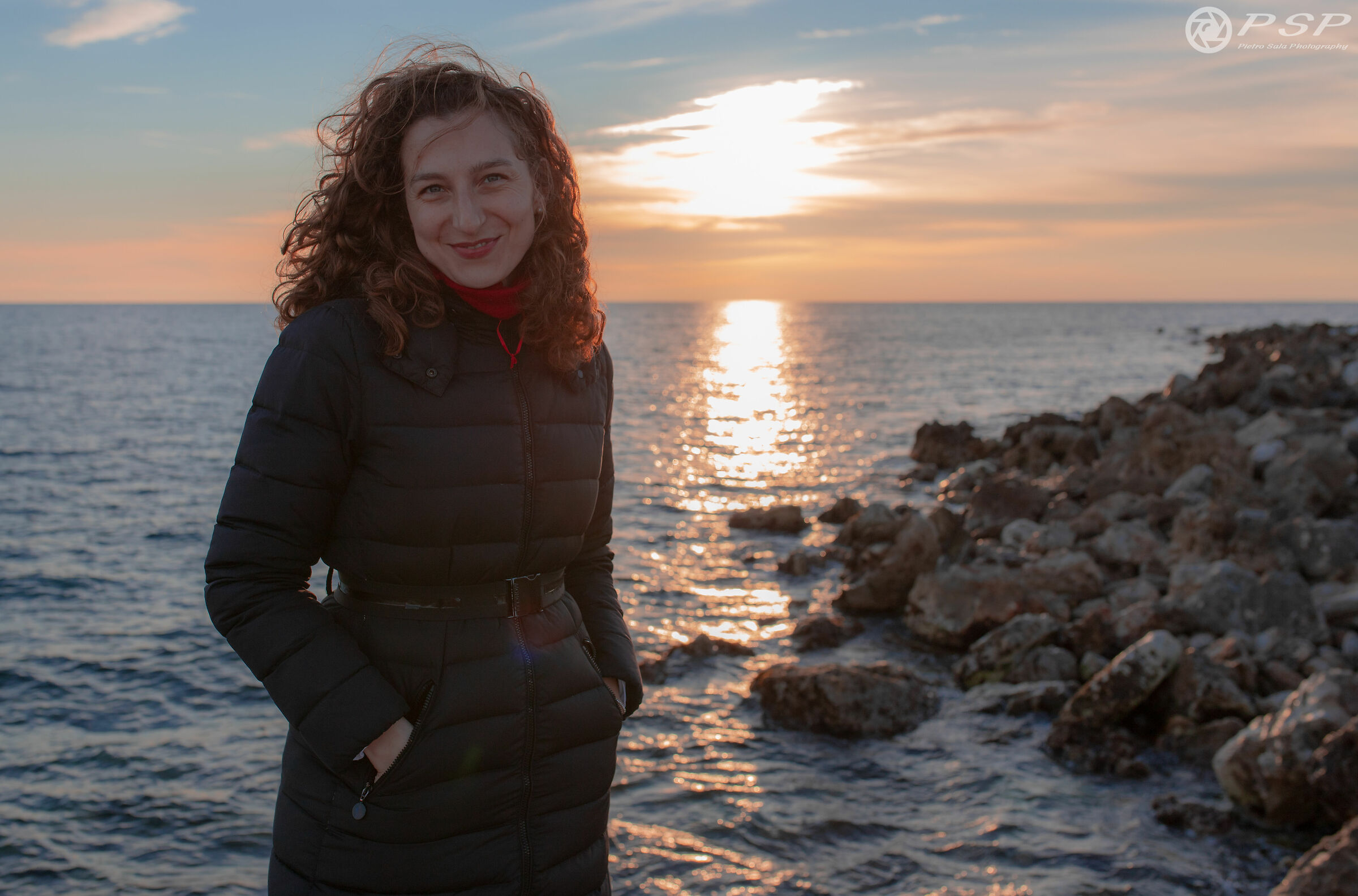 In the background, the sea