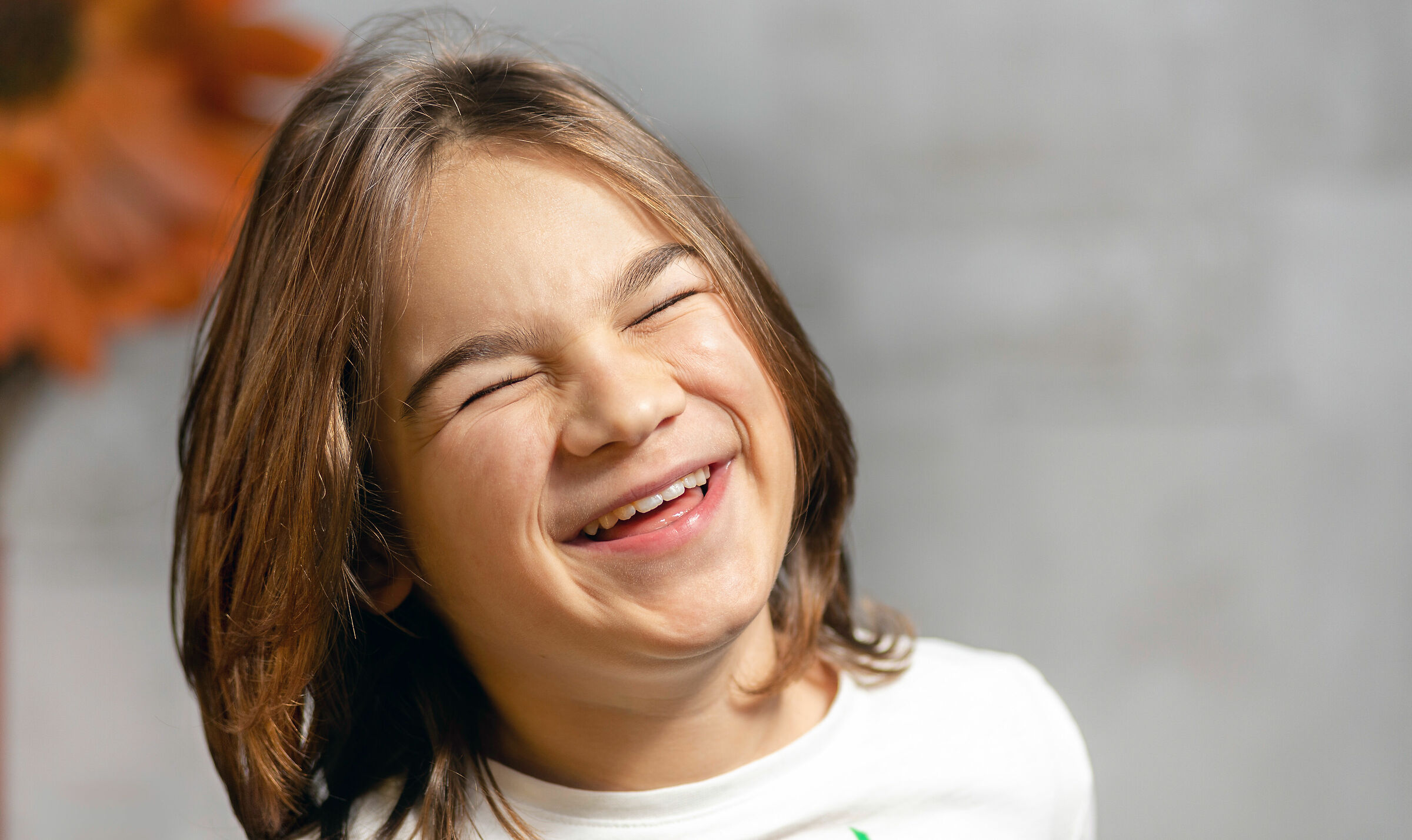 Boy with long hair laughing