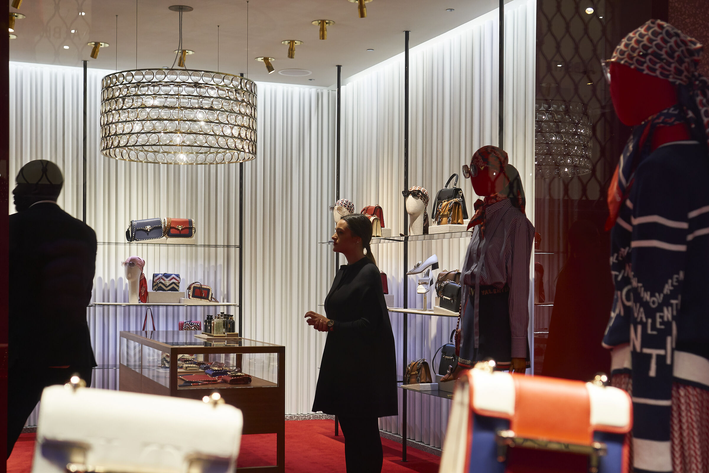 Three mannequins and a bouncer