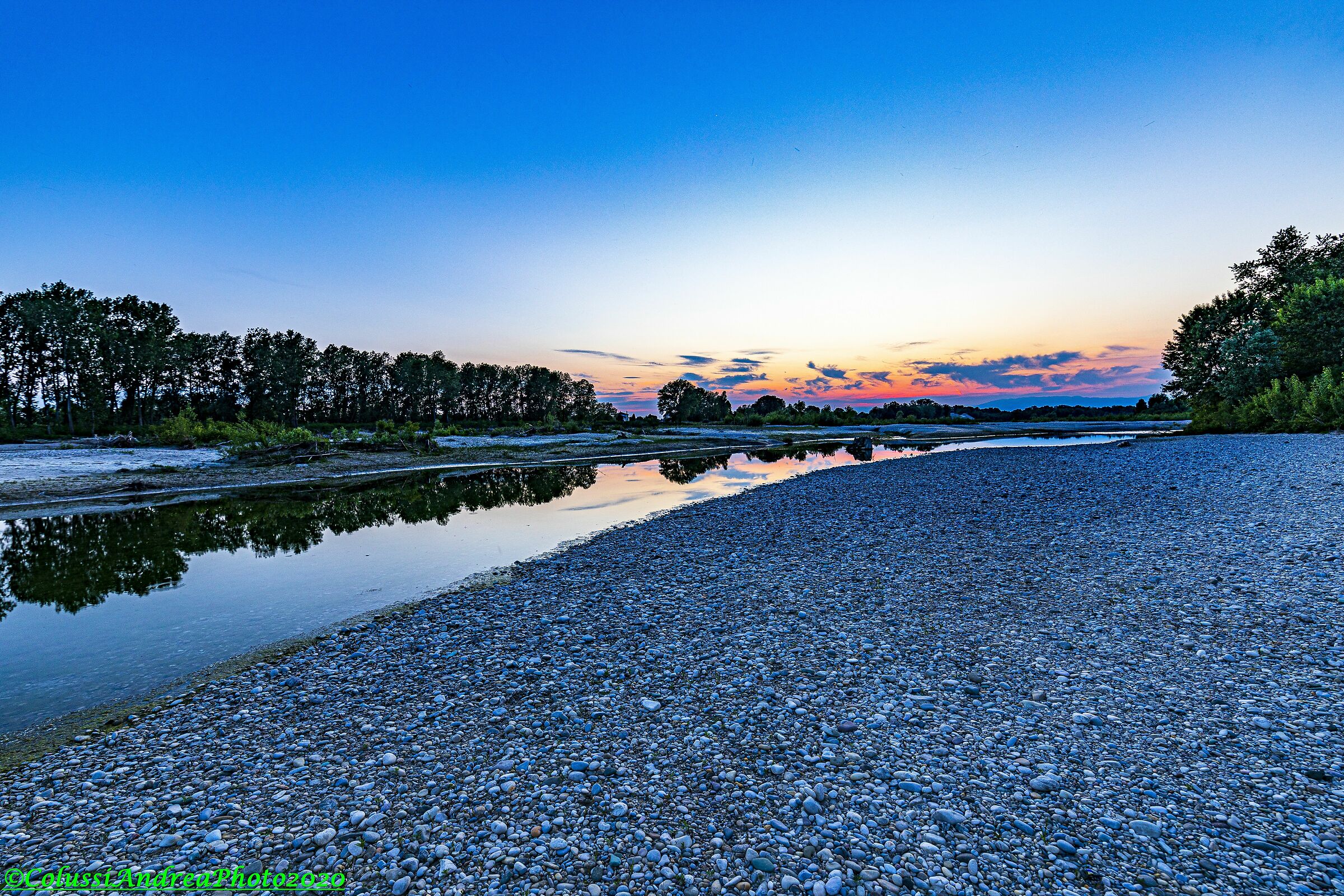 Sun sets on the river piave