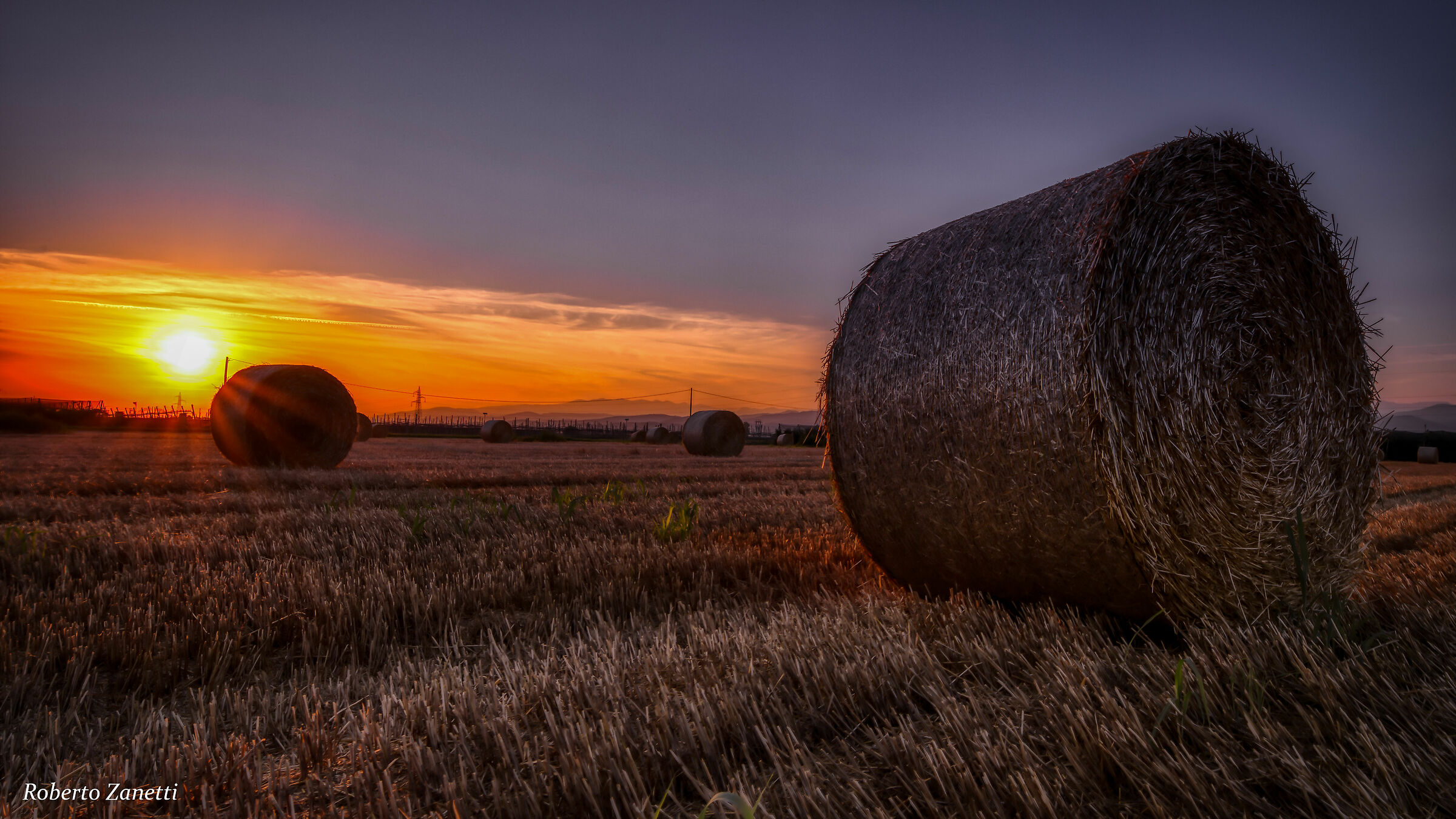 Round bales at sunset