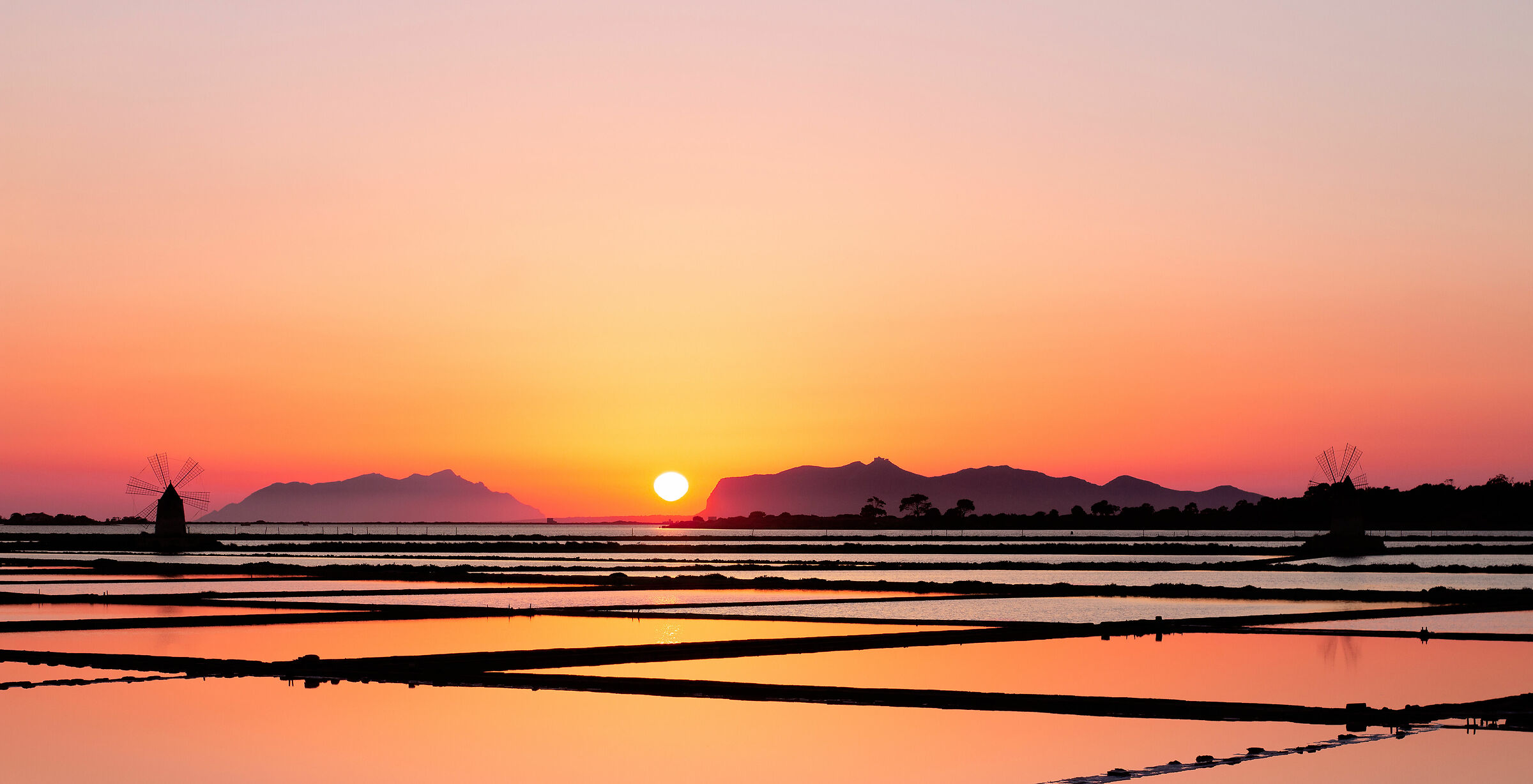 Sunset on salt flats, Egadi and mills