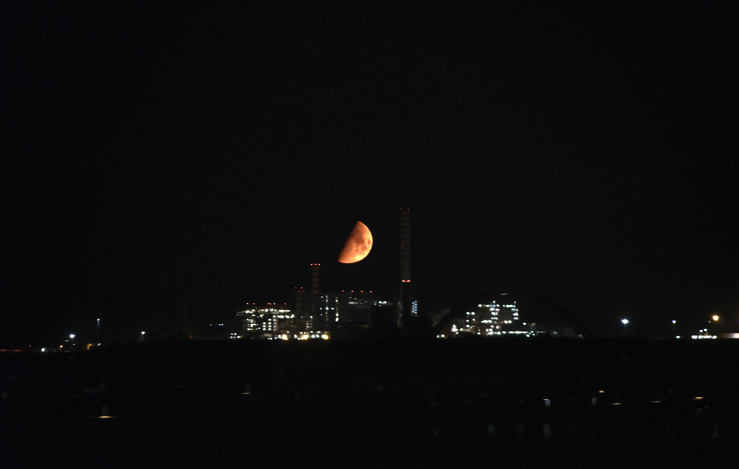 Red moon over the oil plant