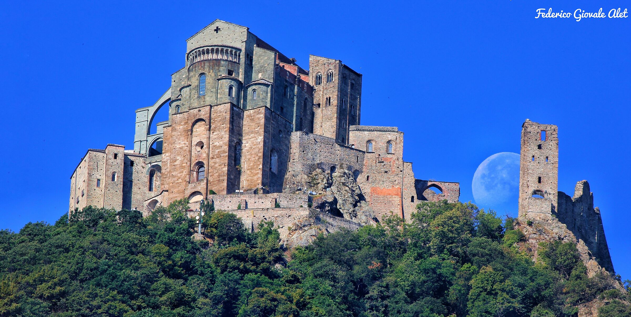 The Moon wedges between Sacred and Tower of the Beautiful Al...
