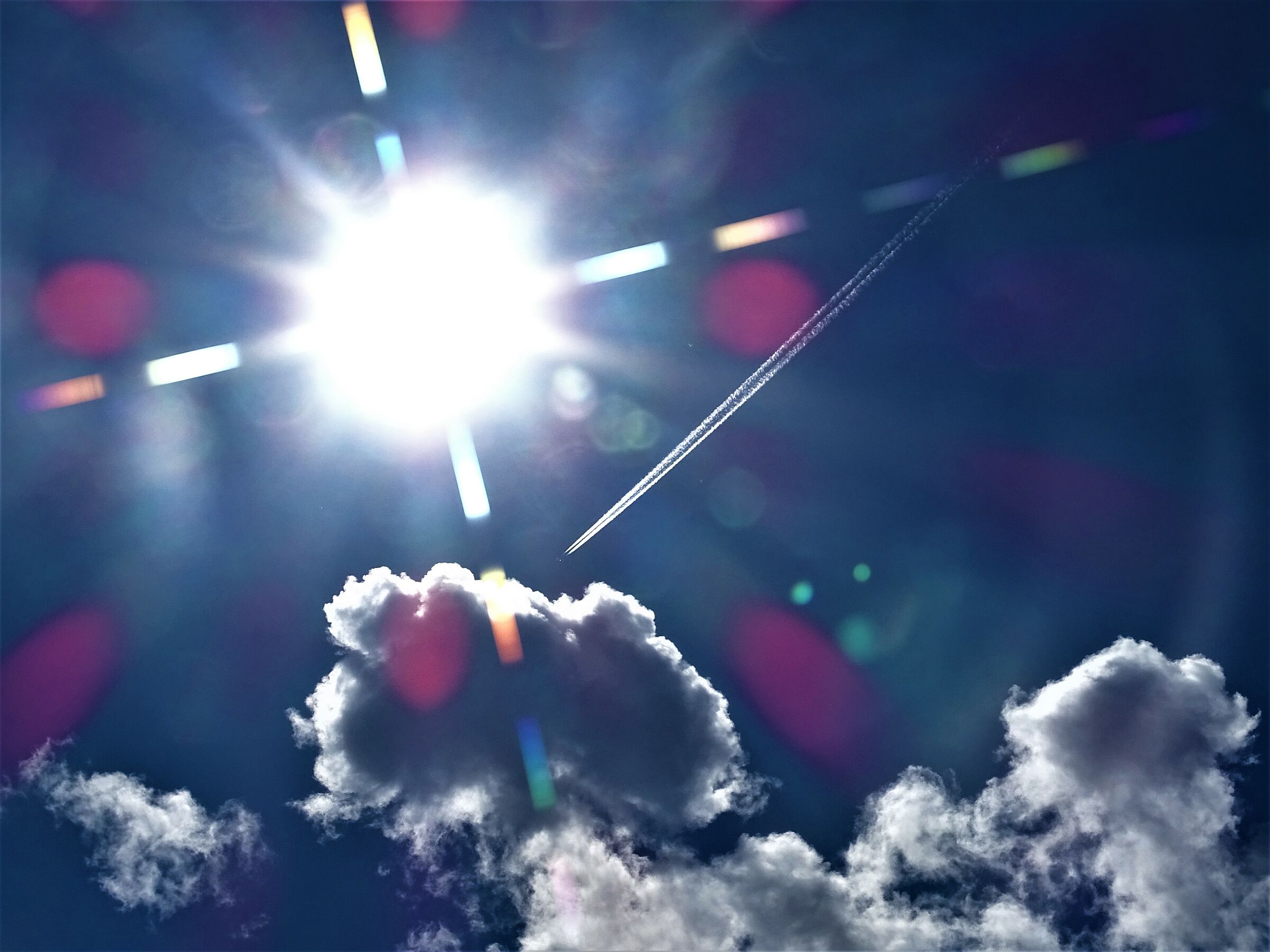 Sun.. Clouds.. passing aircraft..