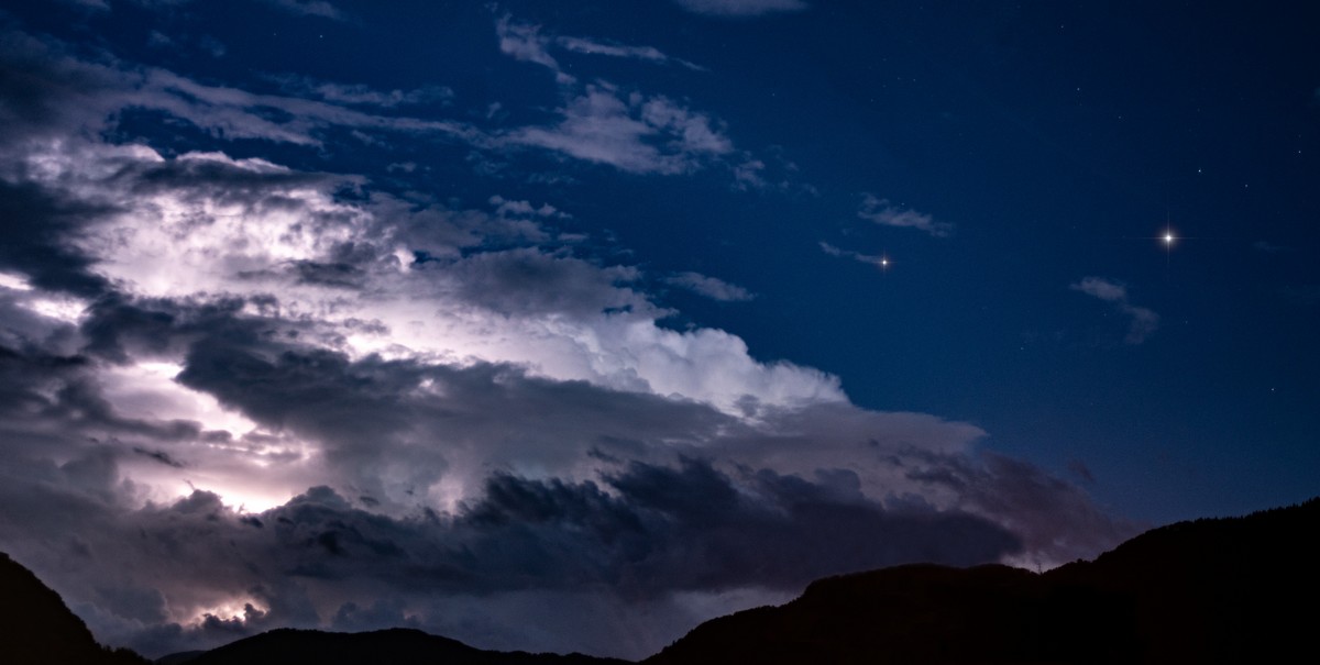 Jupiter and Saturn in a storm sky