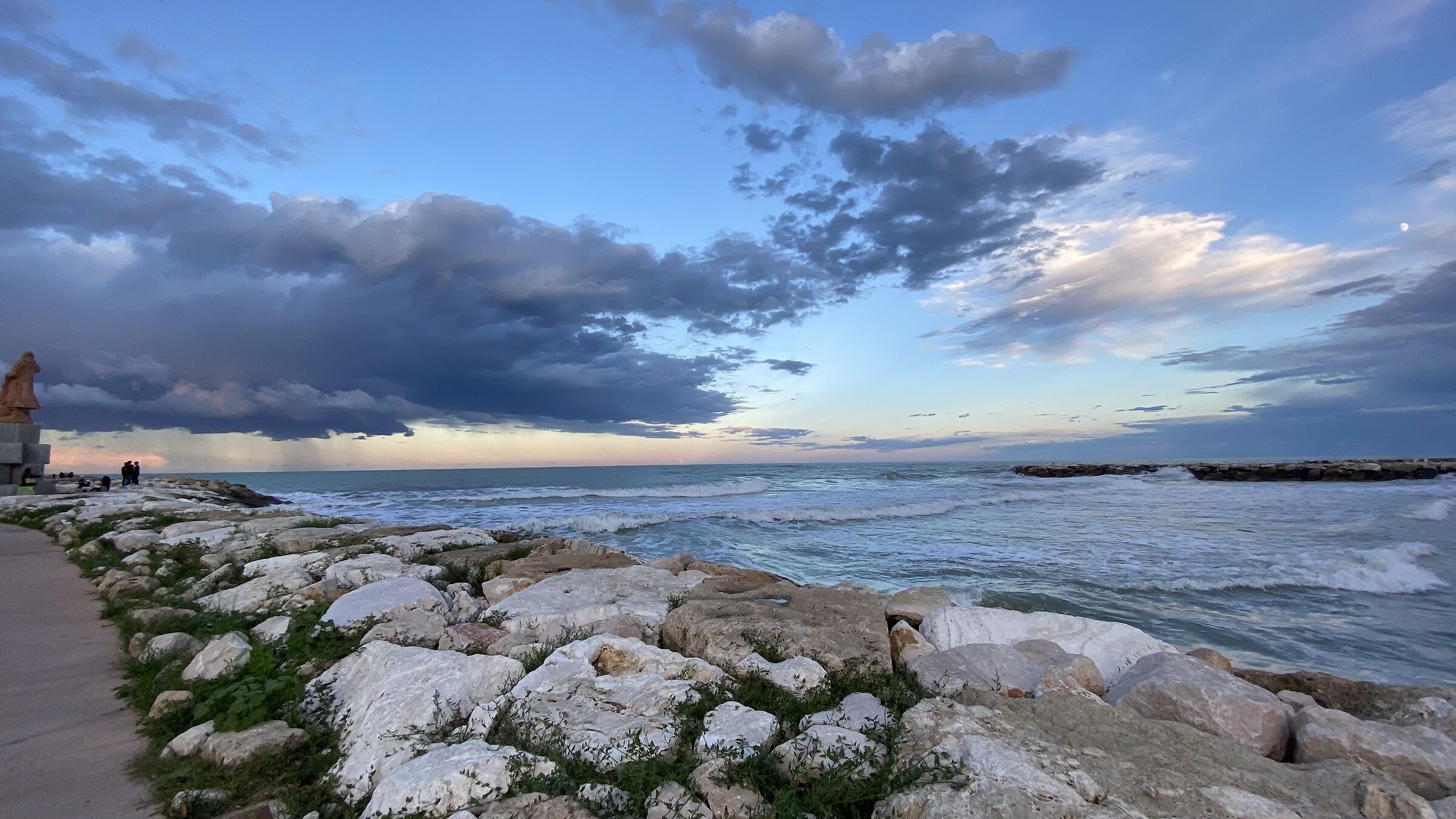 Sunset with a riot of clouds and monument, in the background