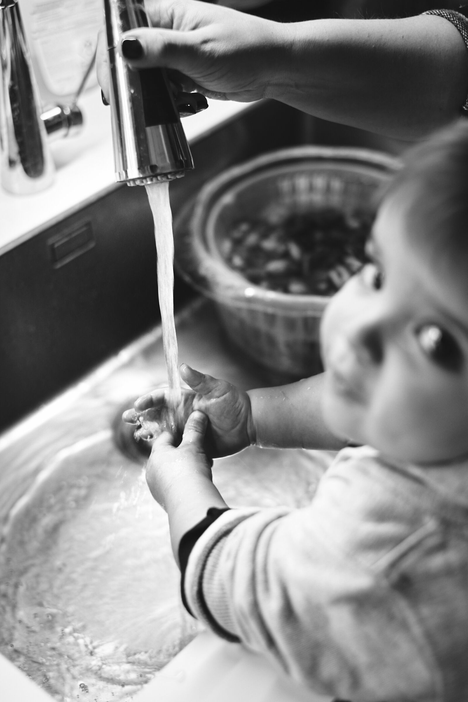 Mother washing son's hands, during dinner