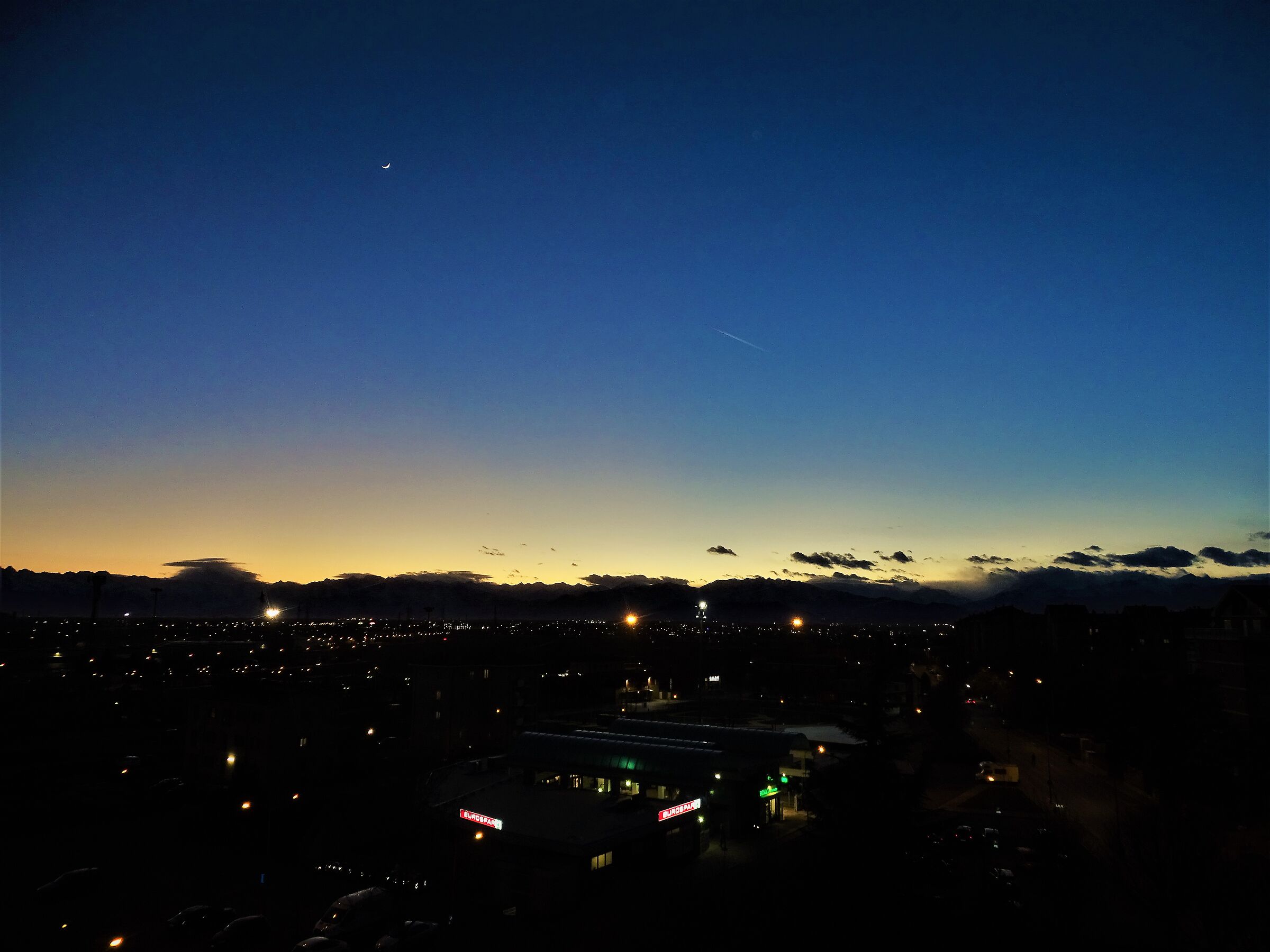 the moon watches over the city...