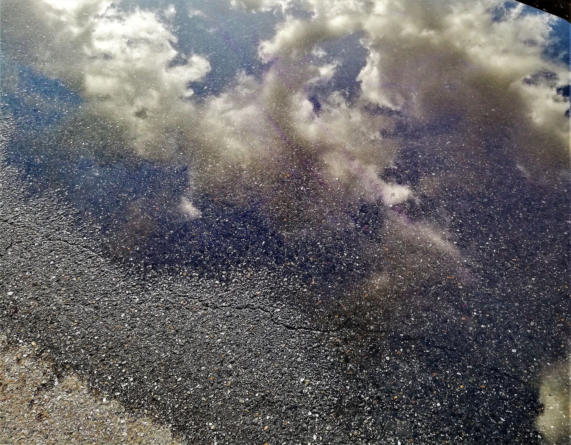 the sky inside a puddle..